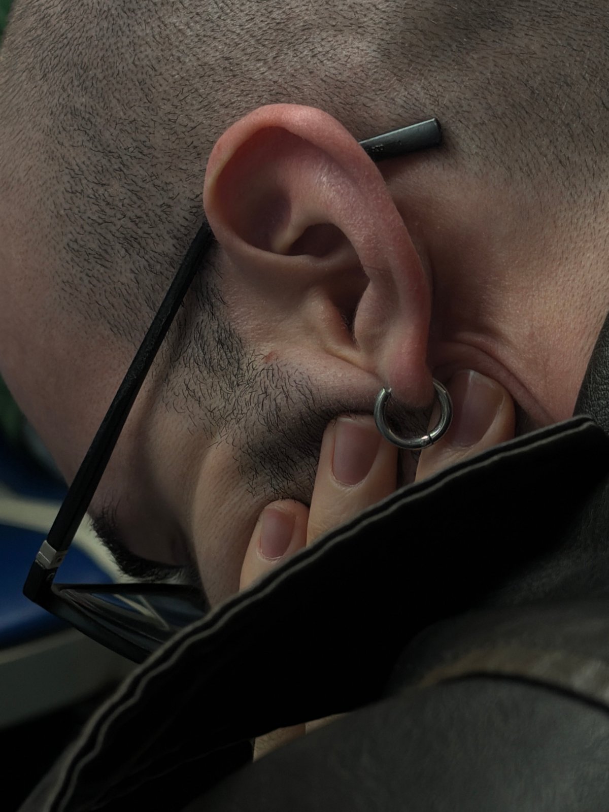 Man with multiple earrings photographed in Moscow