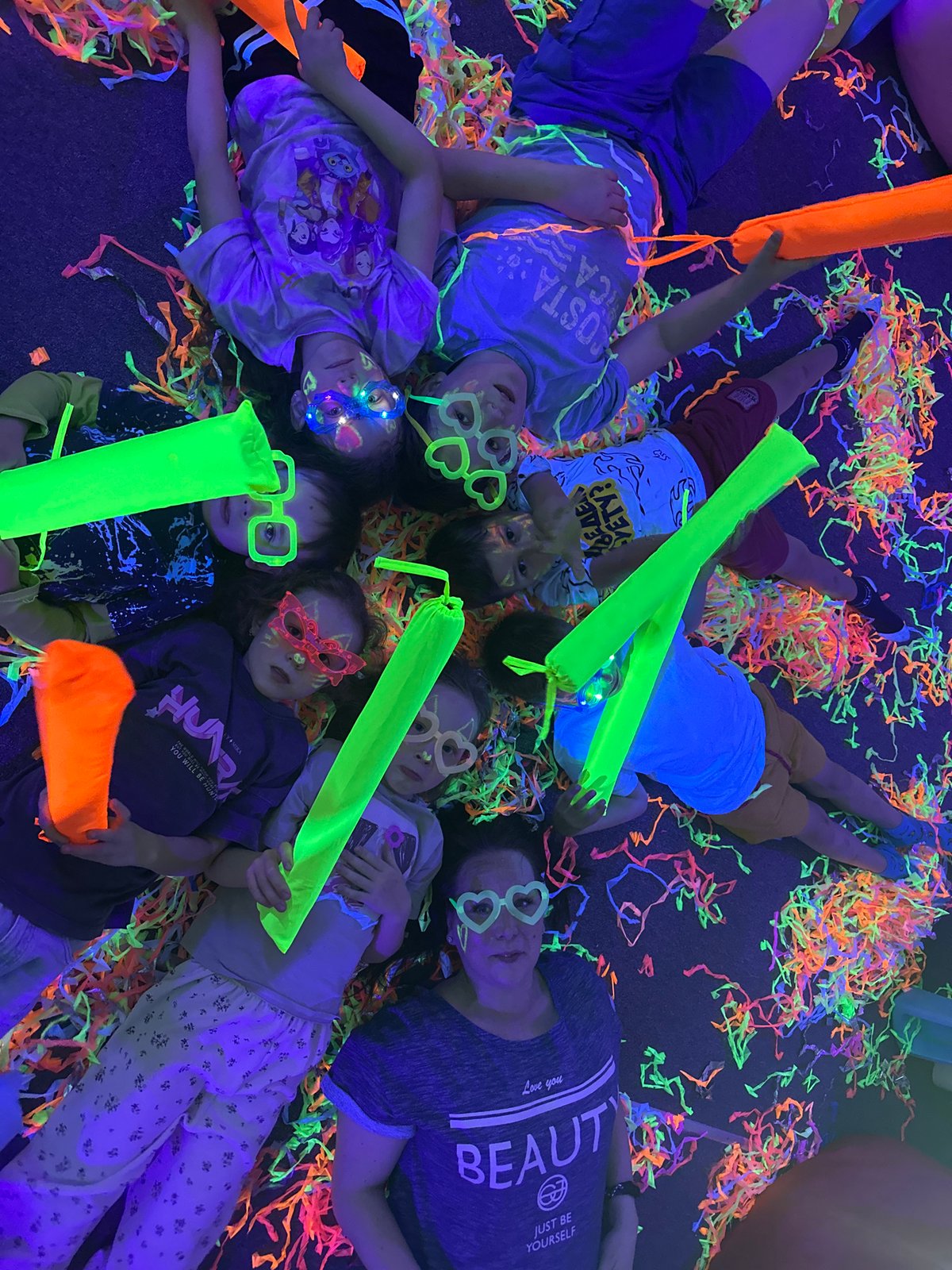 Children's blacklight party features UV face paint and confetti