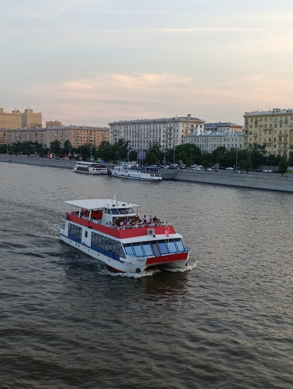 Evening life captured along Moscow's Moskva River during golden hour