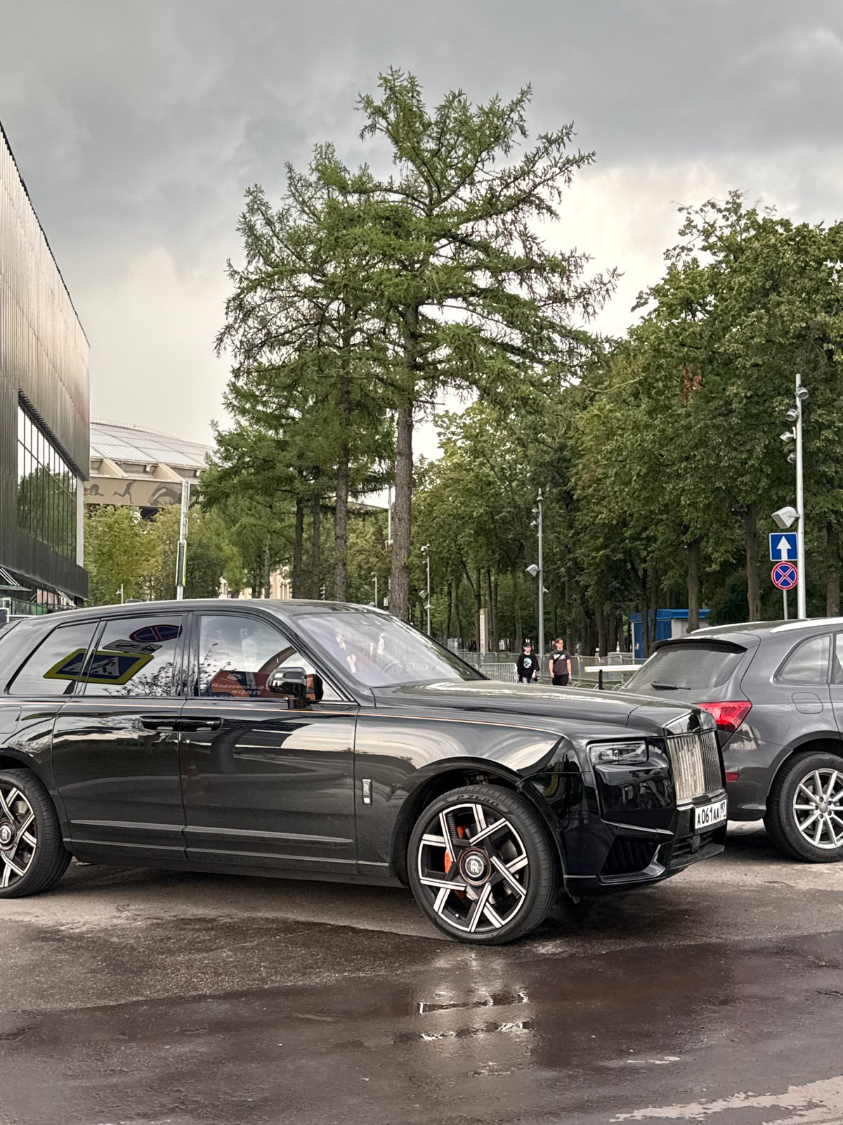 Moscow plaza fountain scene with kids, luxury car, and park sculpture