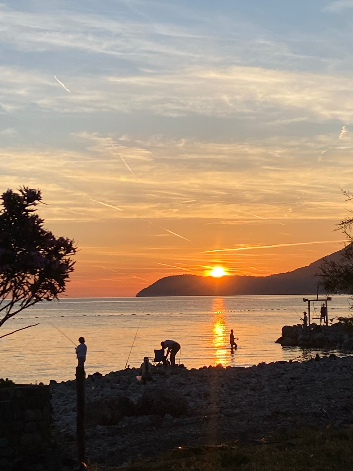 Sunset fishing and coastal leisure captured in Bar, Montenegro