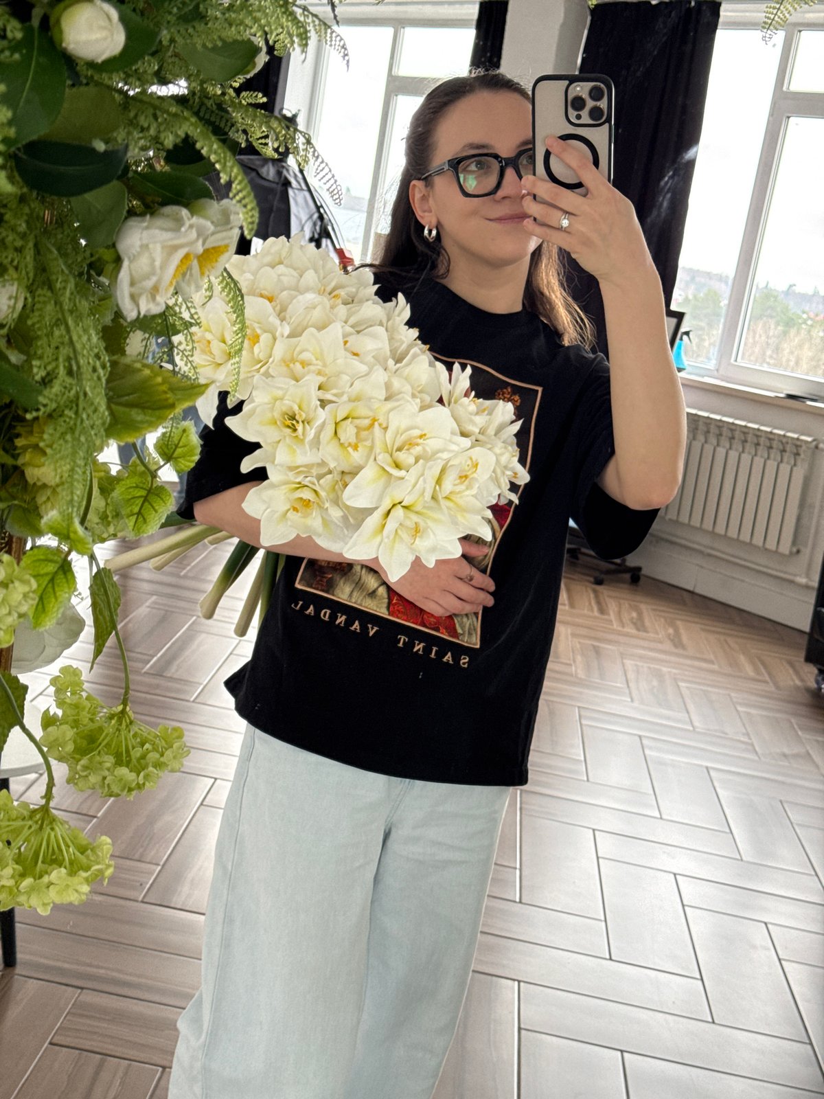 Woman poses with white flower bouquet in Chaikovsky mirror selfie