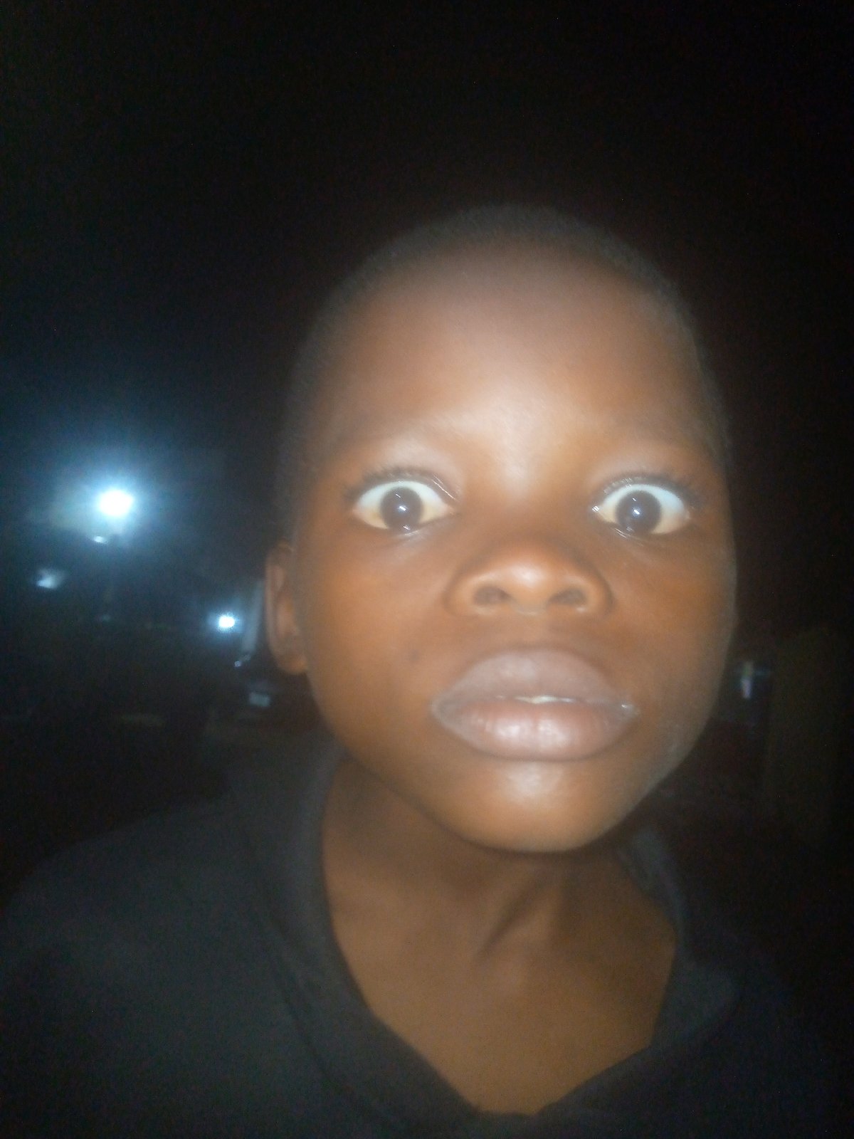 Young person photographed on darkened street in Ikorodu, Nigeria