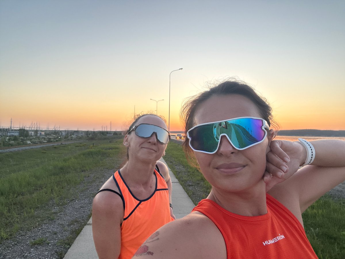 Women take sunset selfies in athletic wear, Chaikovsky Russia