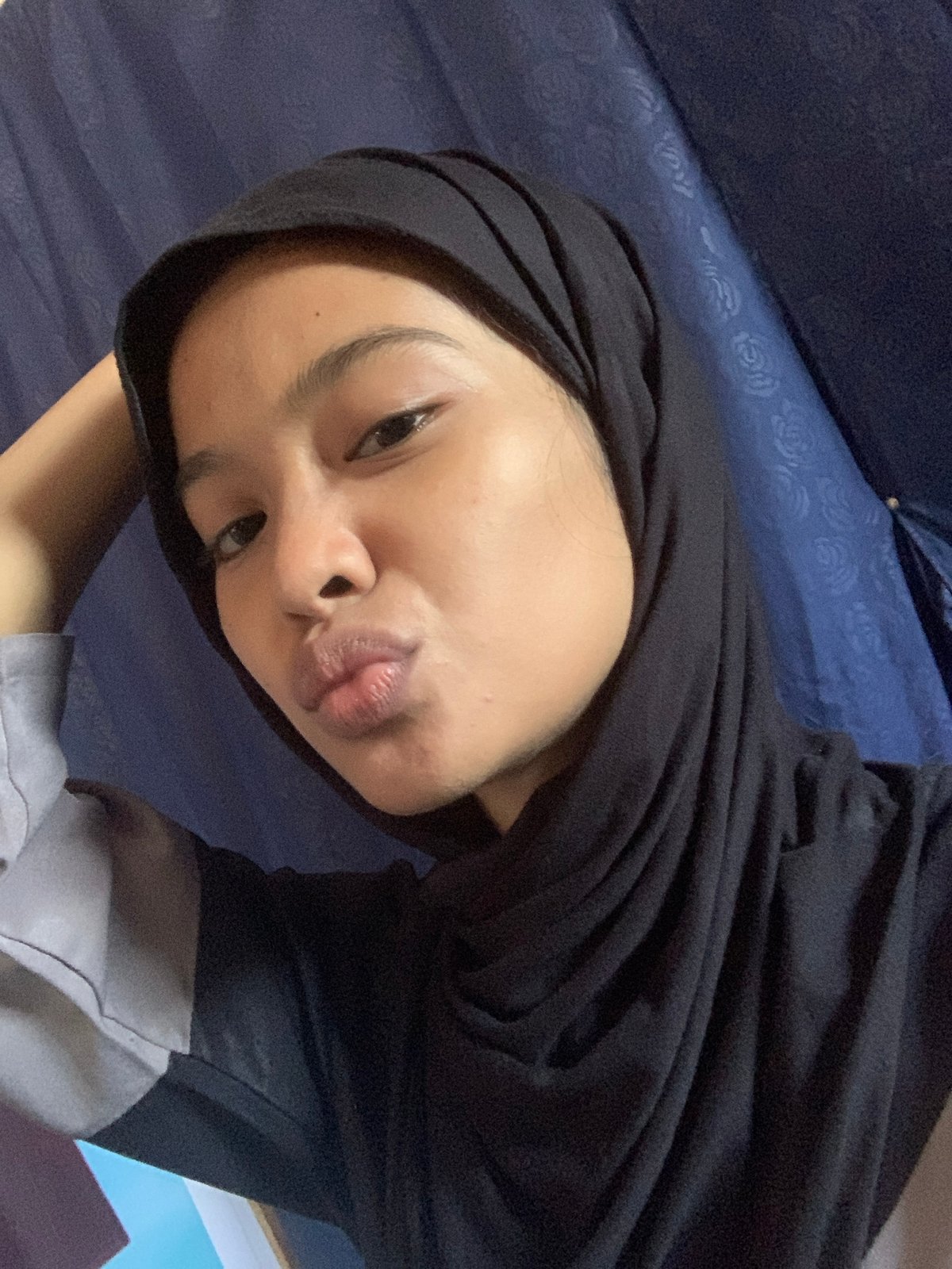 Playful selfie session in front of a blue curtain, Sungai Meriam