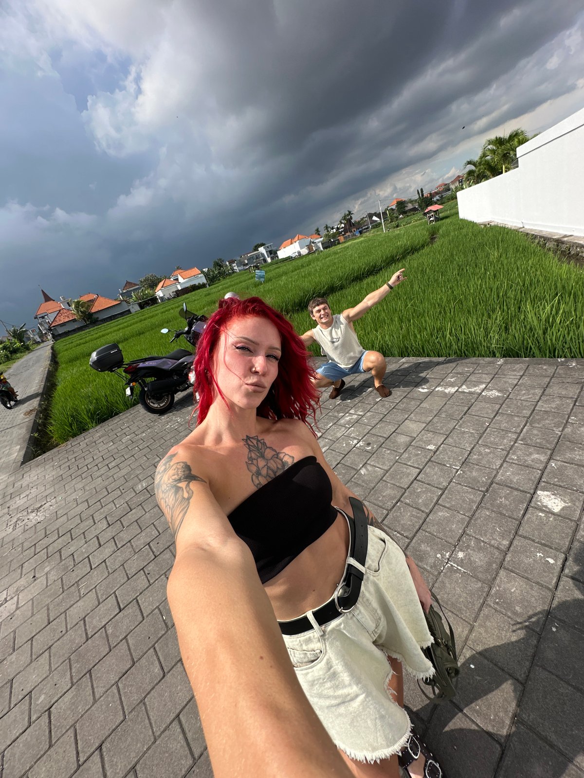 Tourist takes morning selfies near rice fields in North Kuta