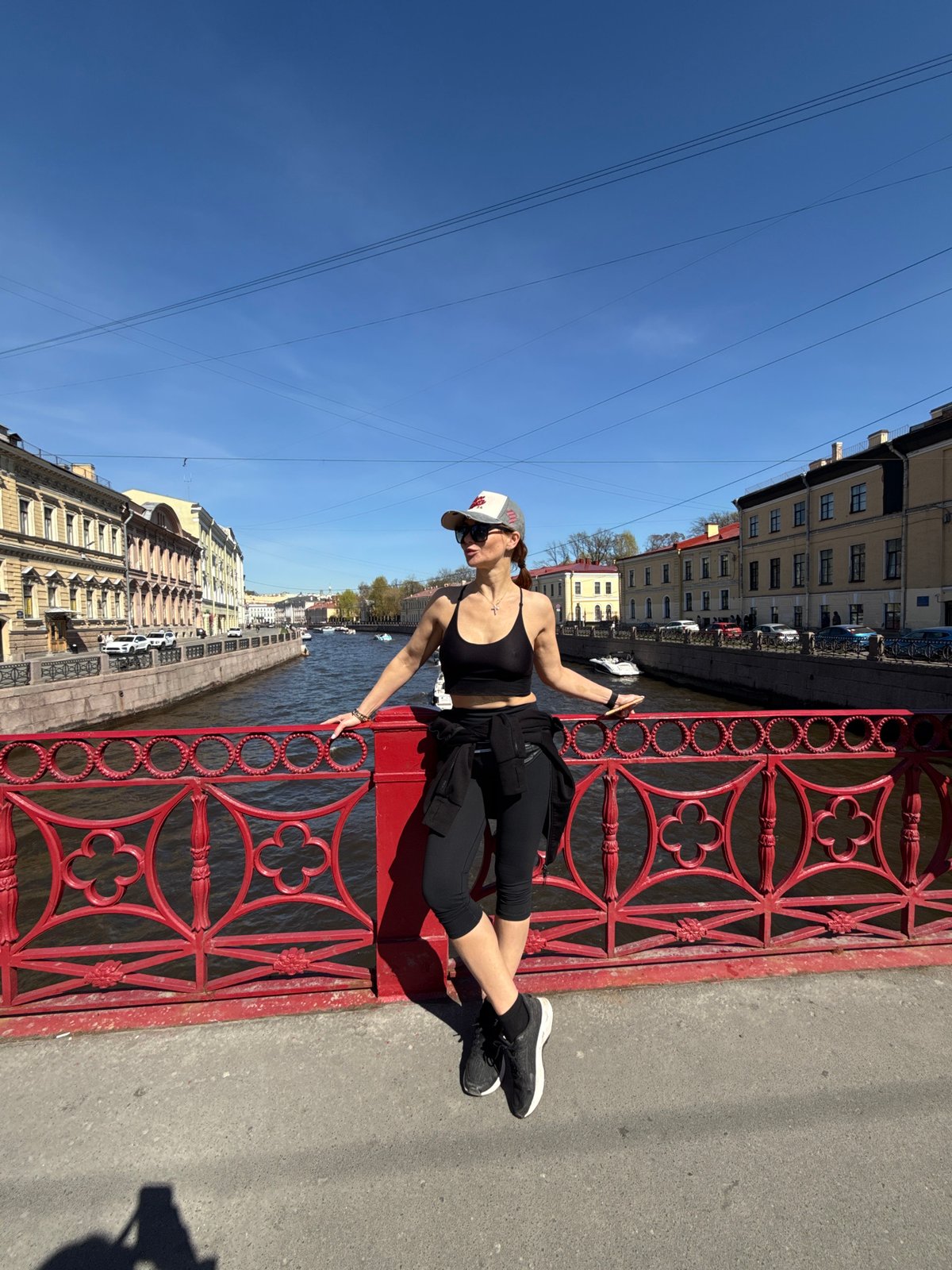 Woman photographed on red bridge in Saint Petersburg
