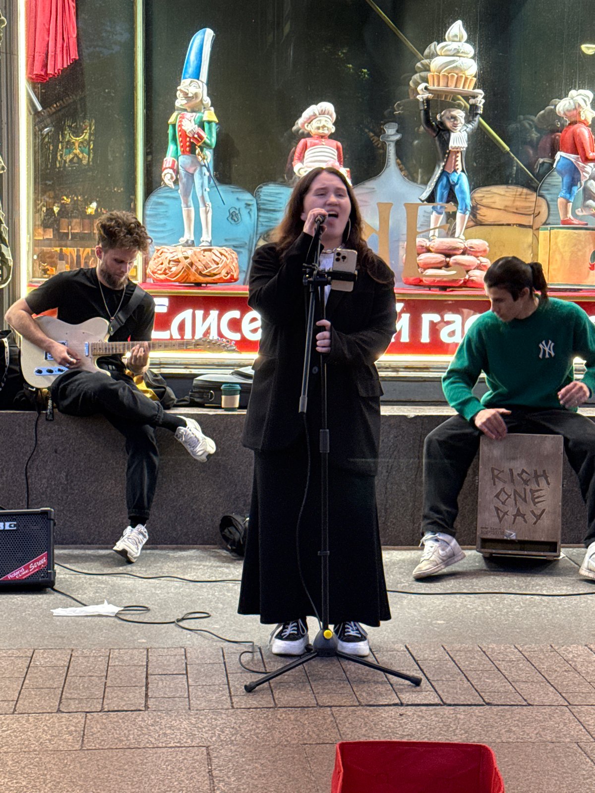 Live street band draws a crowd outside a Saint Petersburg storefront