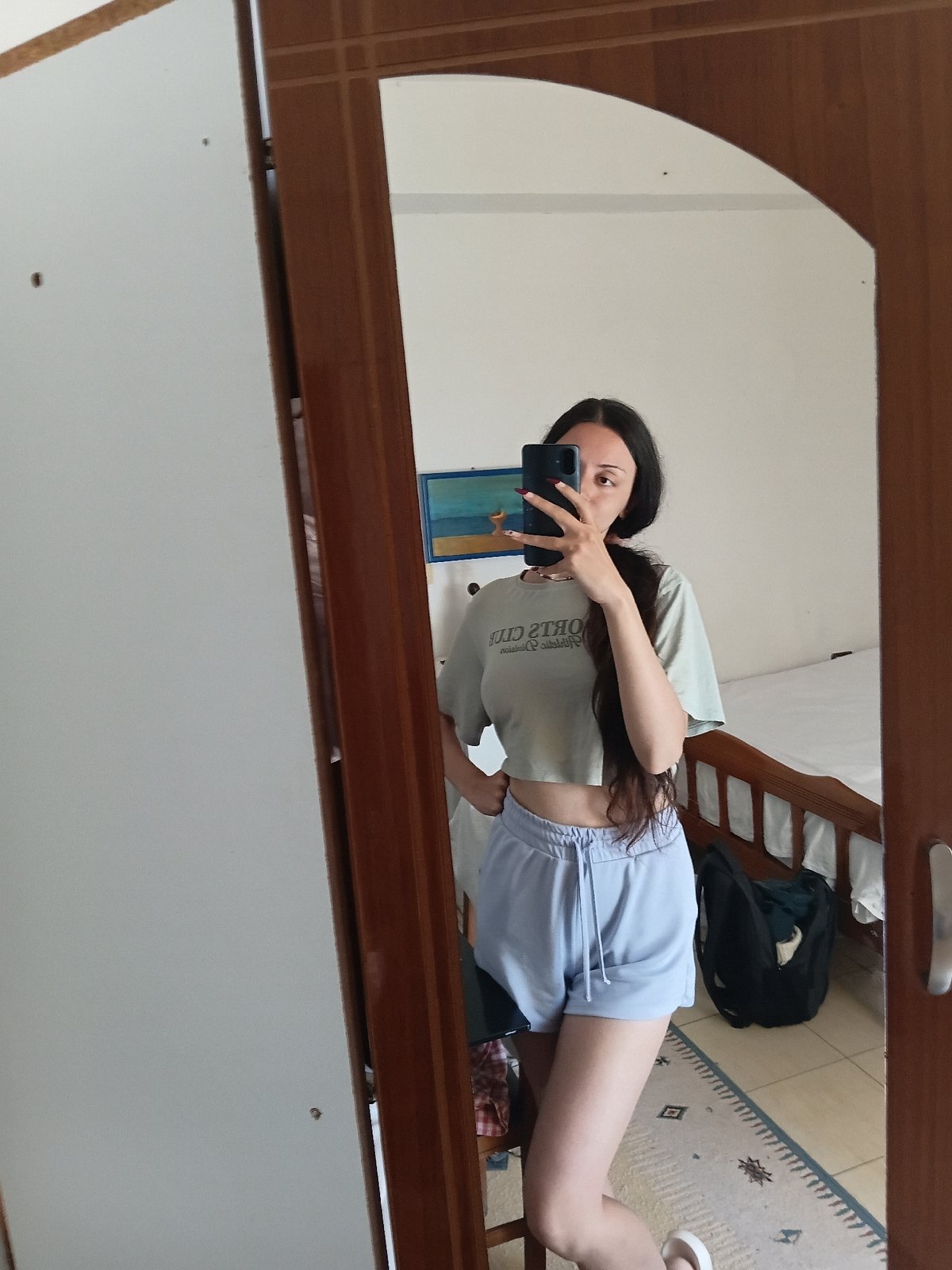 Woman takes morning selfies in bedroom mirror, Vlora Albania