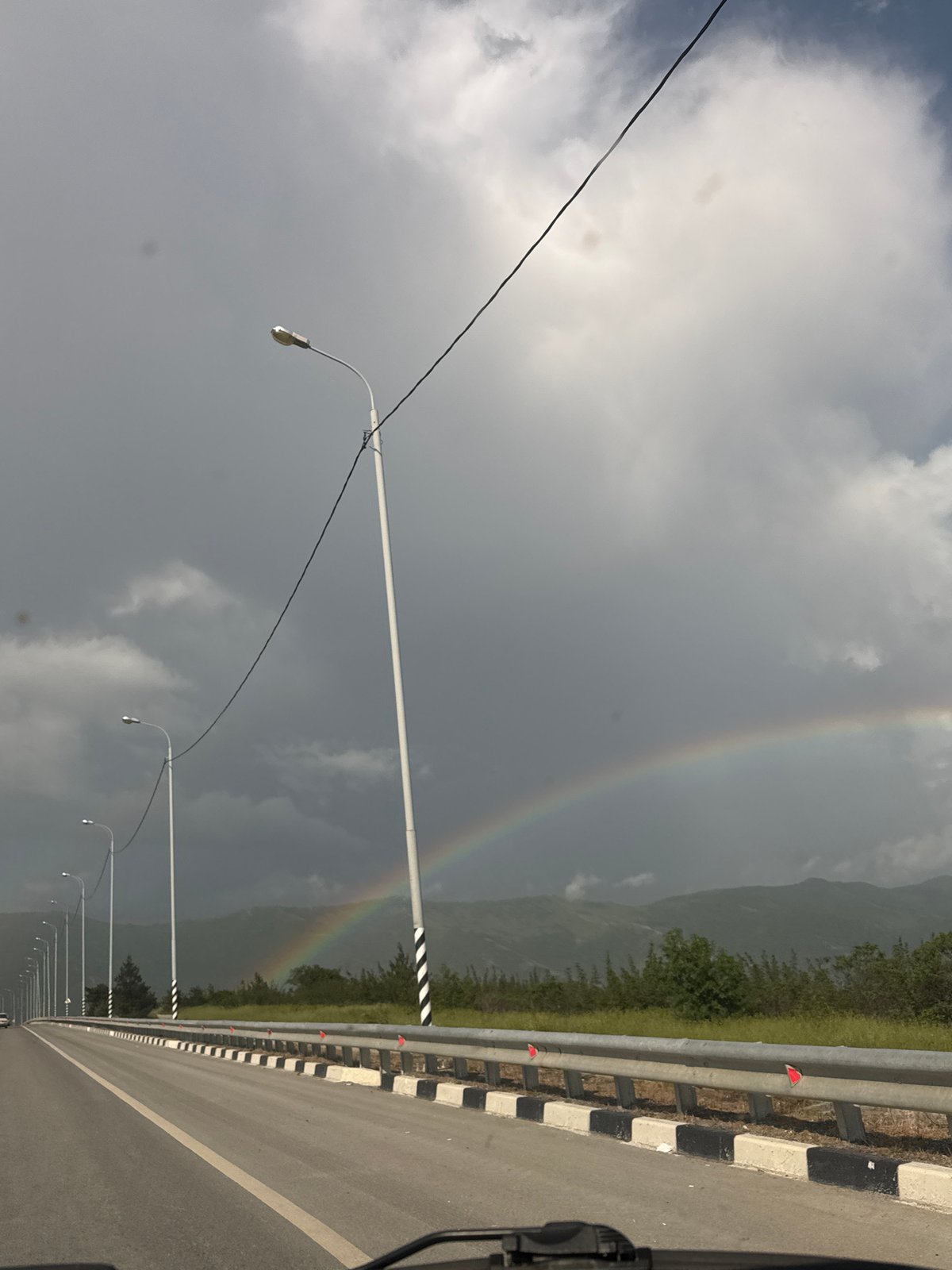 Rainbow appears over Gelendzhik coastal city amid overcast skies