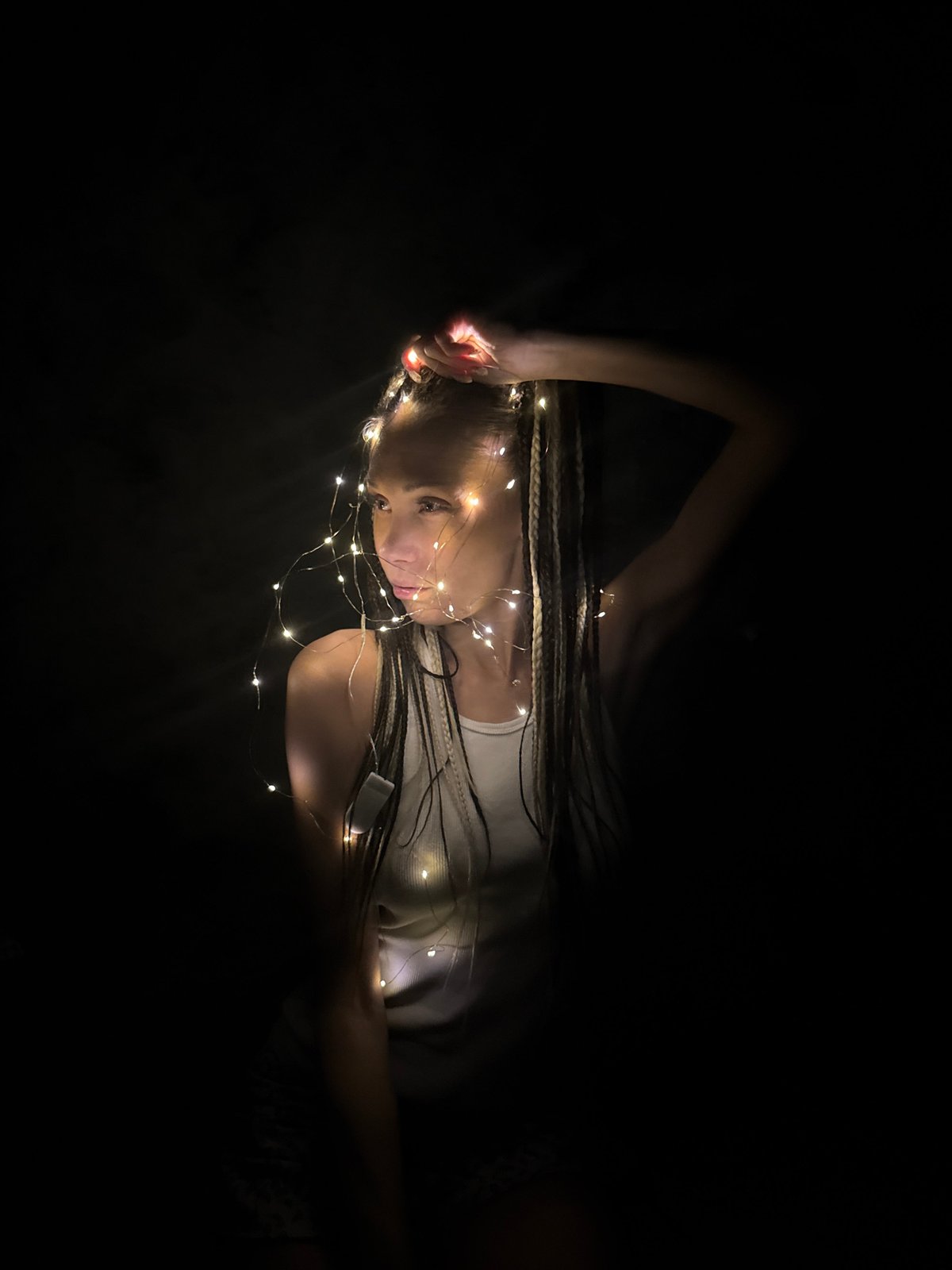 Person rests among fairy lights in Zhukovo, Russia
