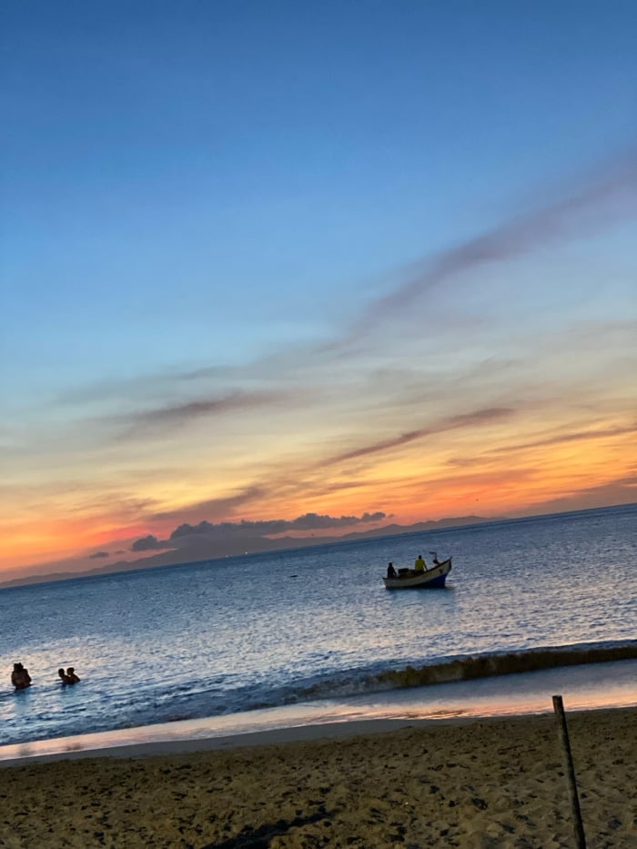 Sunset beach gathering captured at Juan Griego, Venezuela