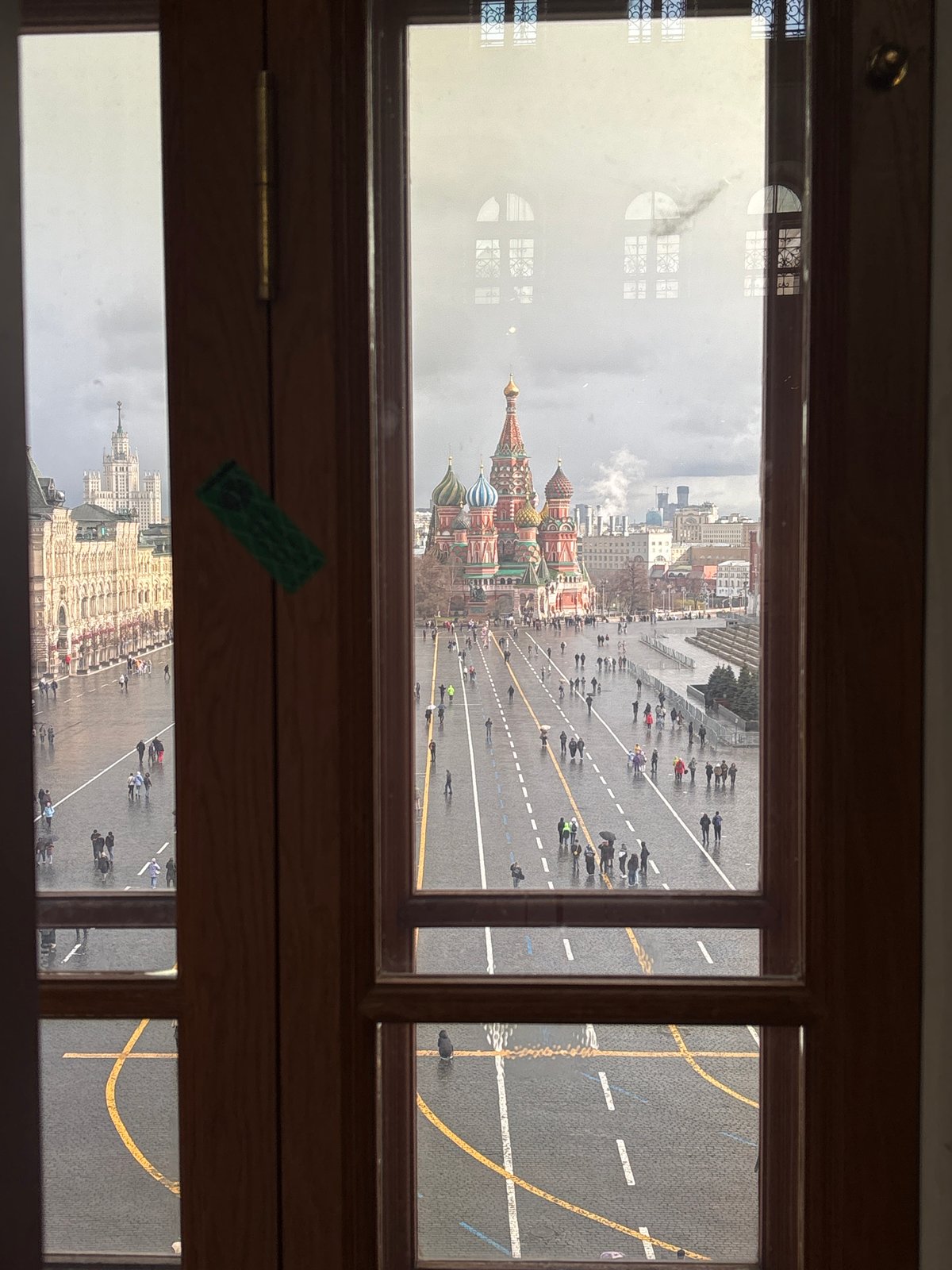 Museum visitors document Red Square views, ornate carriage display