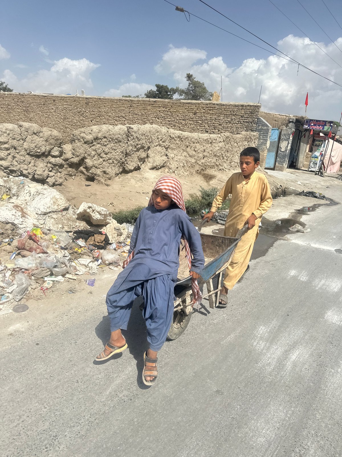 Wheelbarrow ride on a dirt road in Quetta