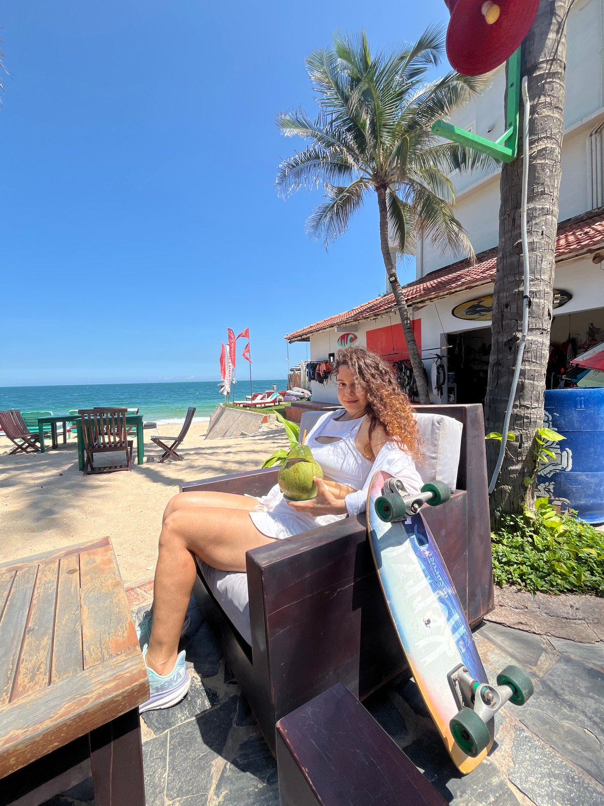 Coconuts and surfboards on a sunny Phan Thiết beach morning