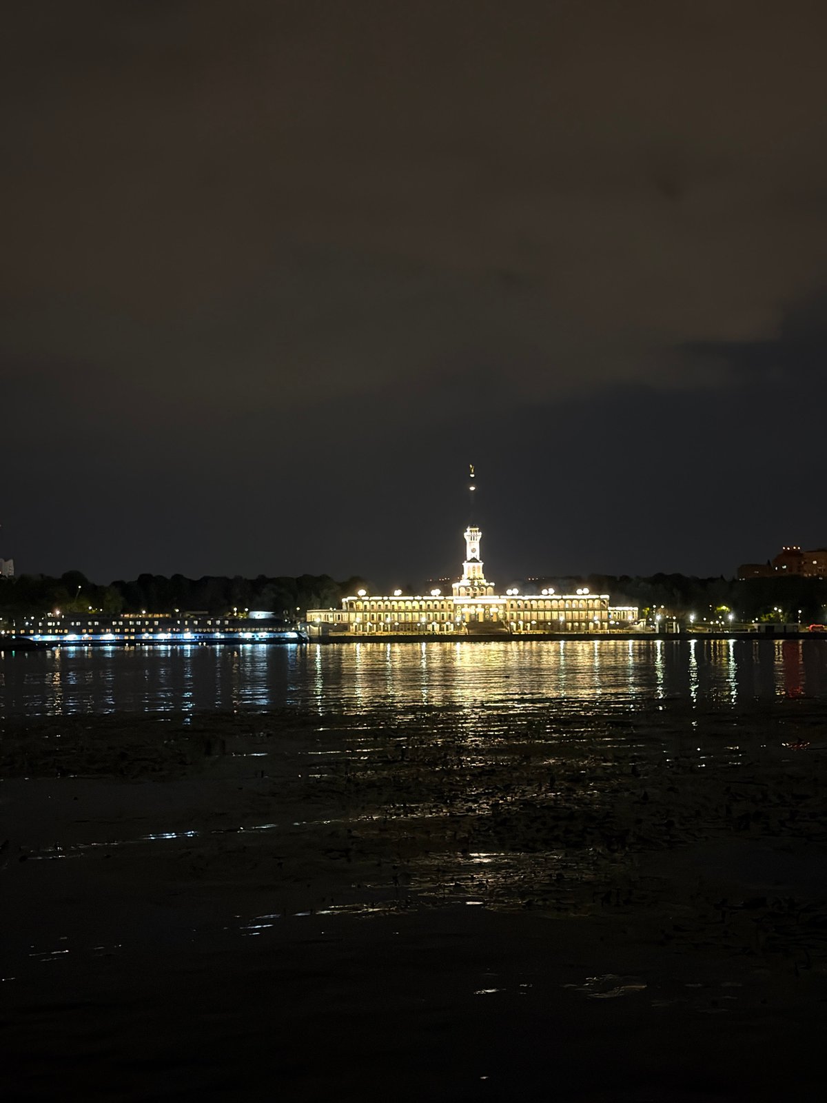 Khimki's river terminal lit up on a summer night