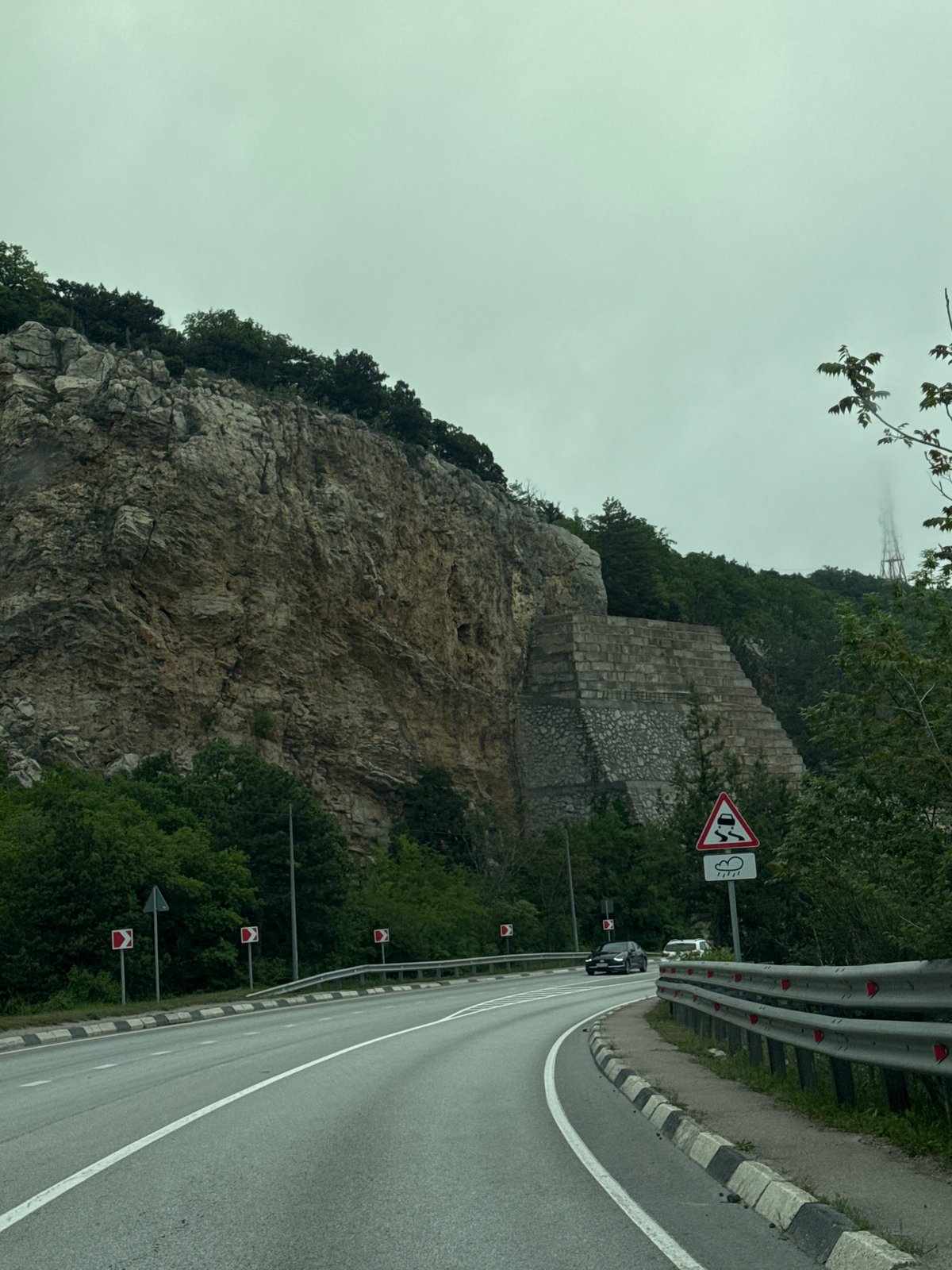 Clifftop road with guardrails observed in Crimean coastal community