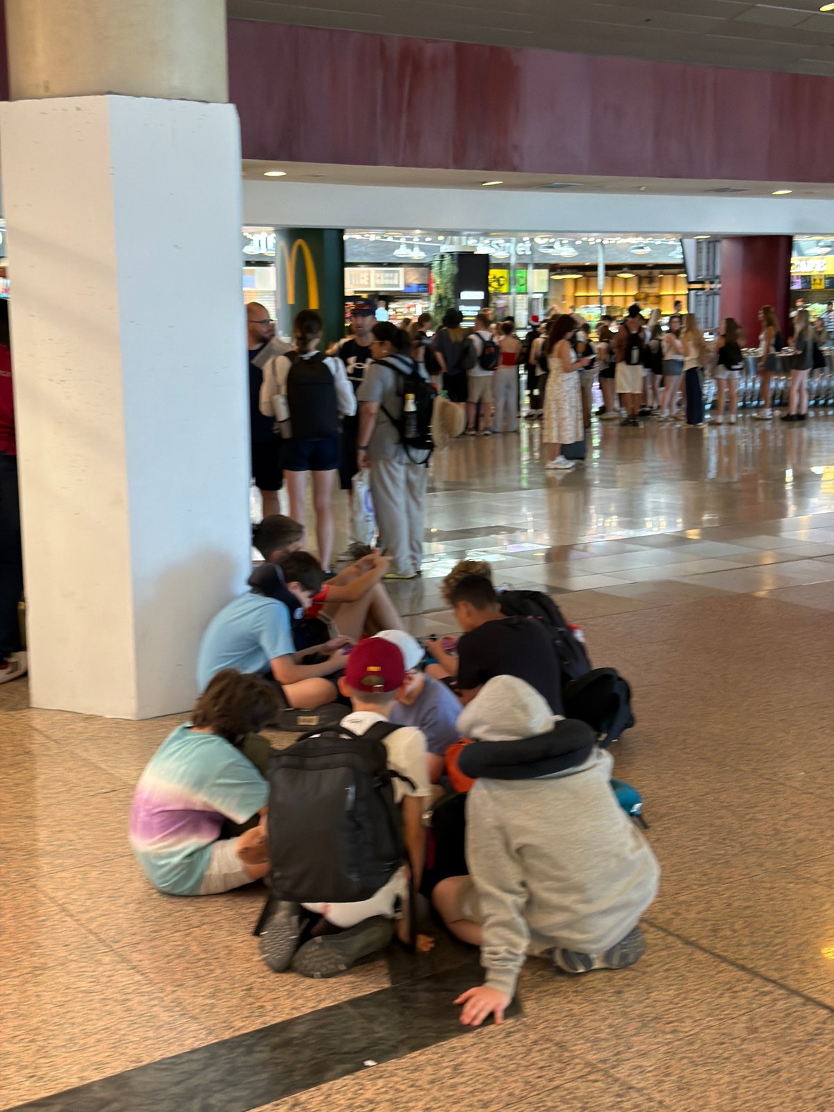 Busy afternoon crowd flowing through Barcelona-El Prat Airport terminal