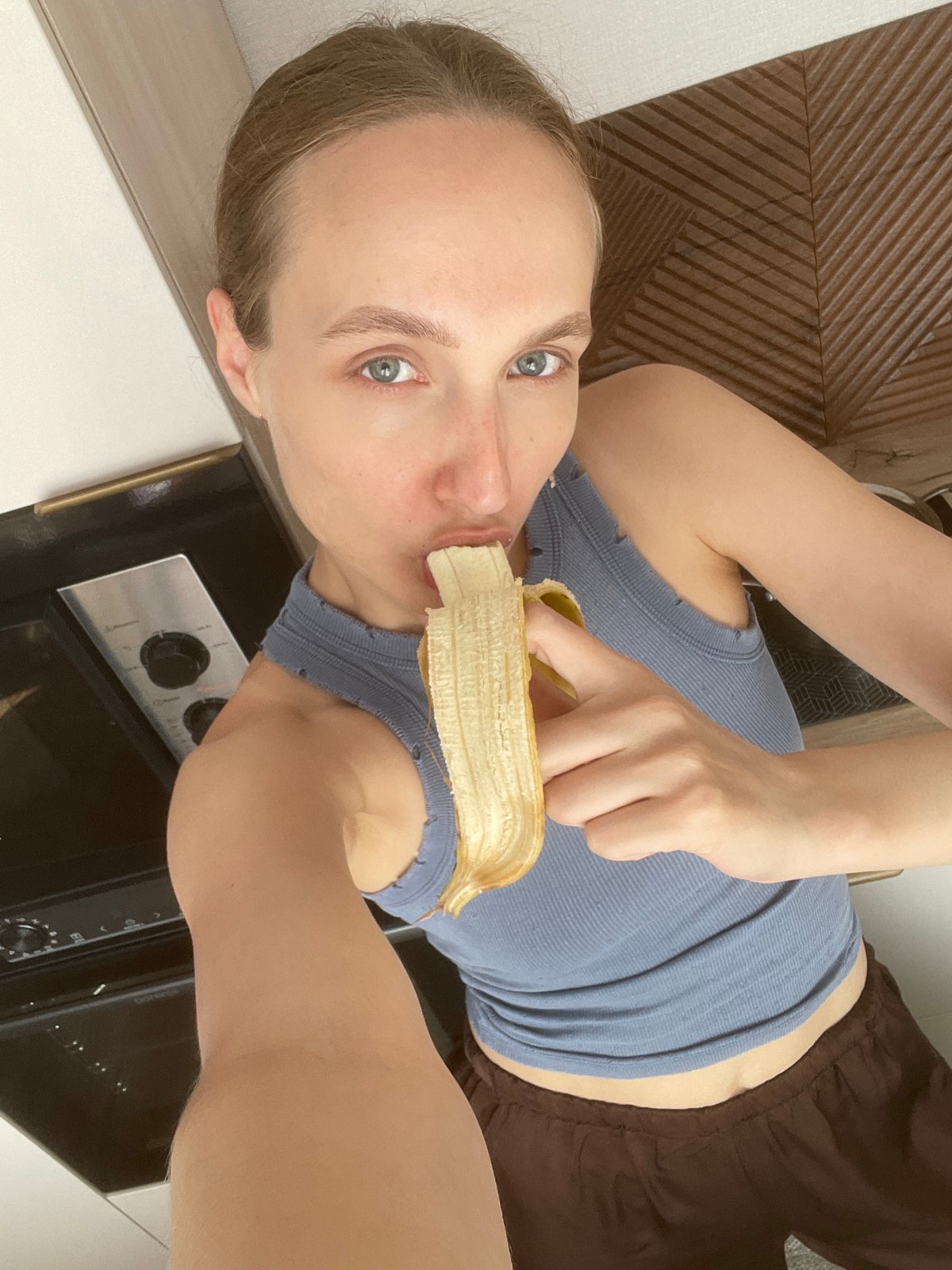 Woman eating banana in Russian kitchen caught on camera