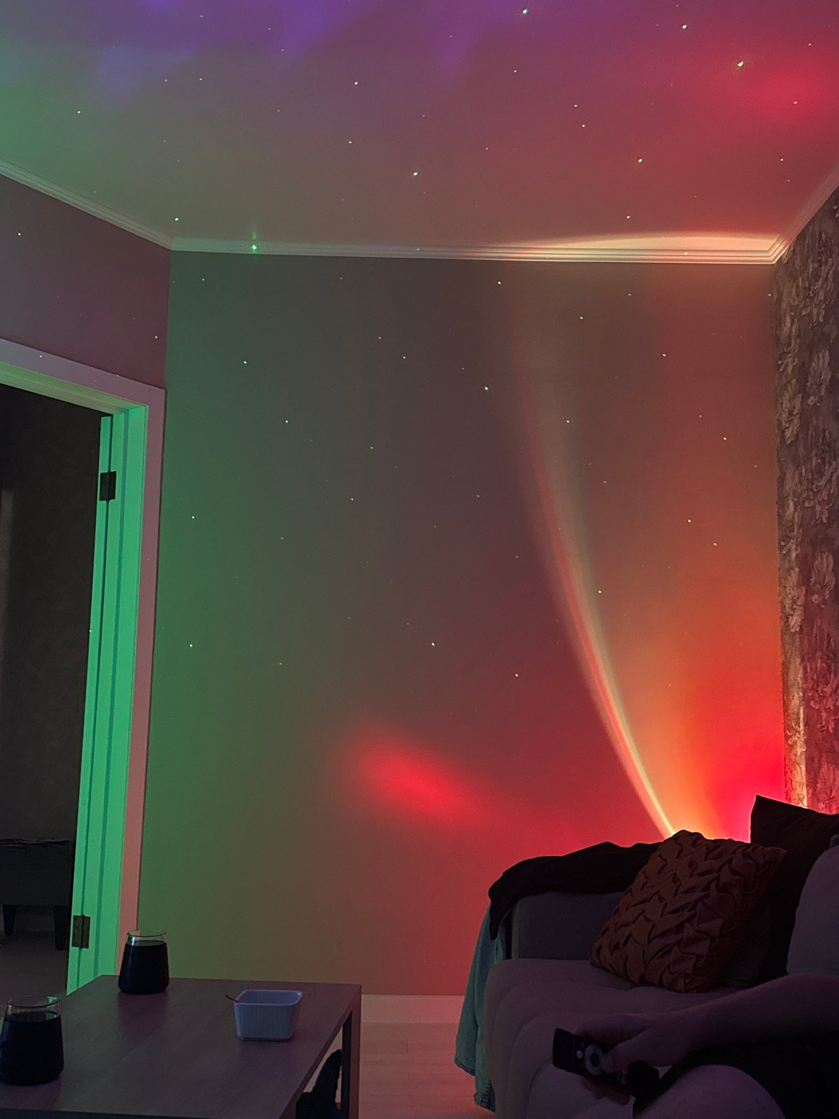 Home documented with colorful projection lighting and dining setup