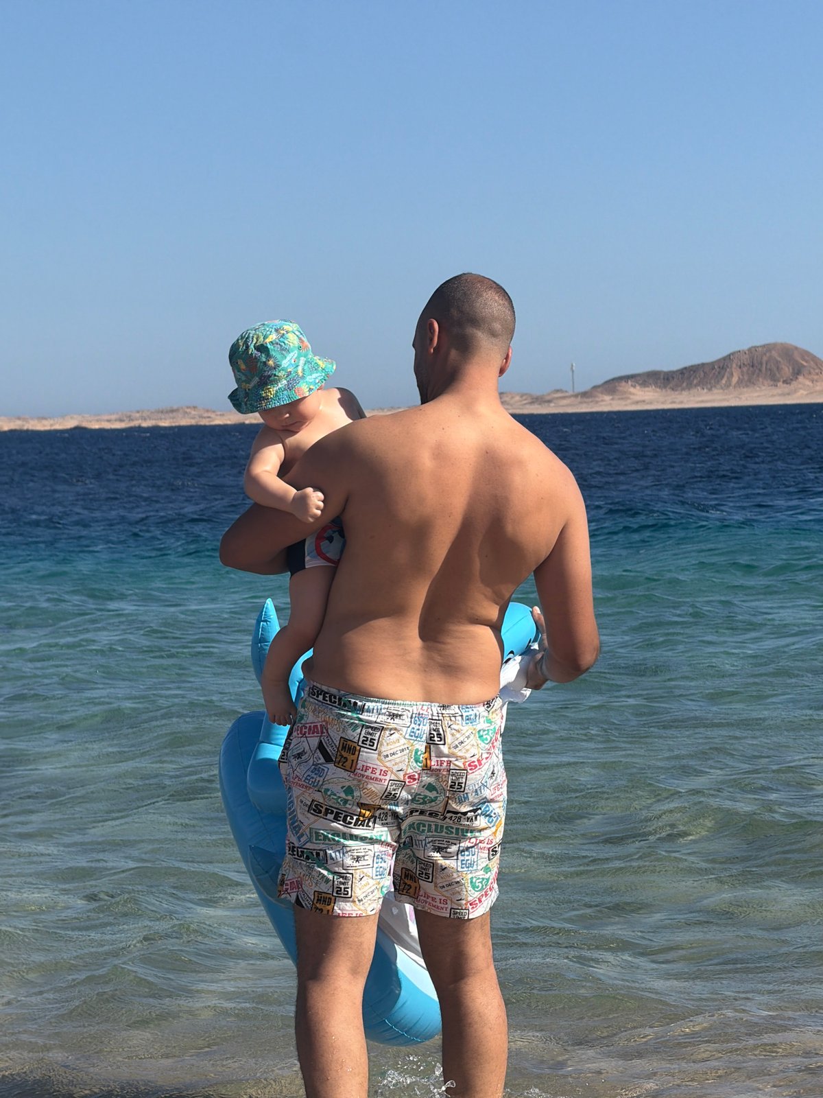 Family beach day in the shallows at Sharm El Sheikh