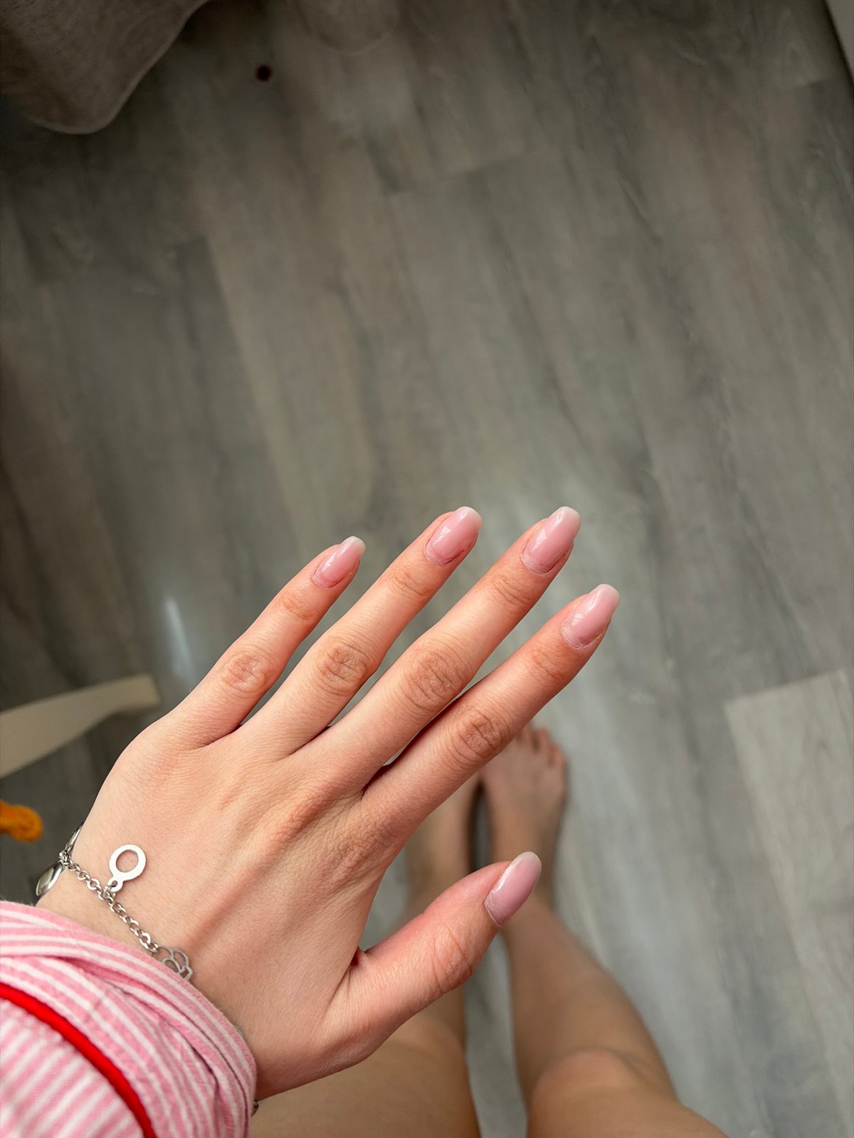 Person documents fresh pink manicure in morning photos