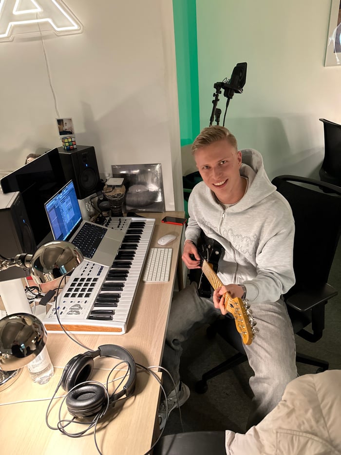 Musician records with electric guitar in London studio