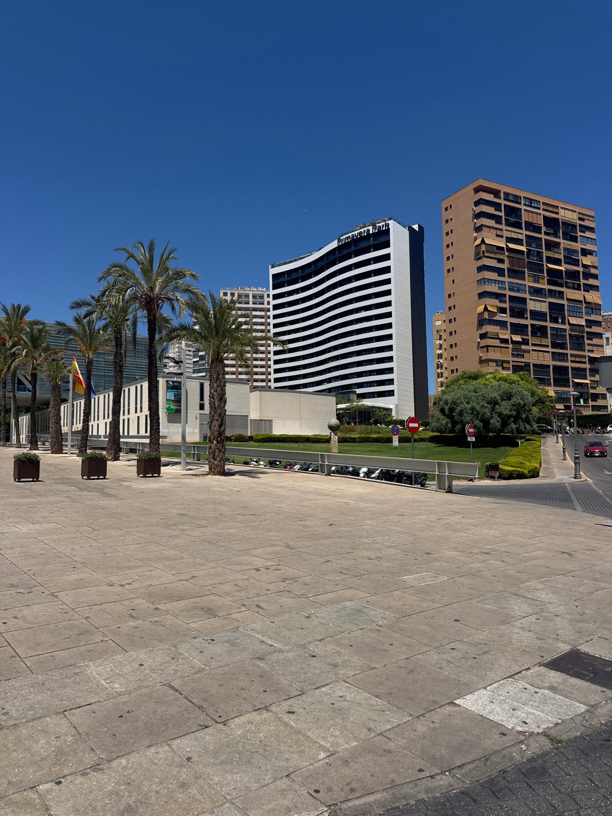 Sunny afternoon on a Benidorm street with cafés and modern buildings