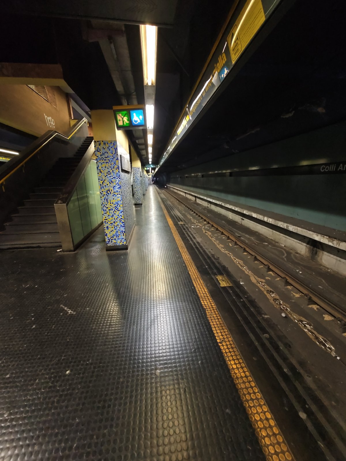 Empty Naples metro platform and tunnel, early morning.