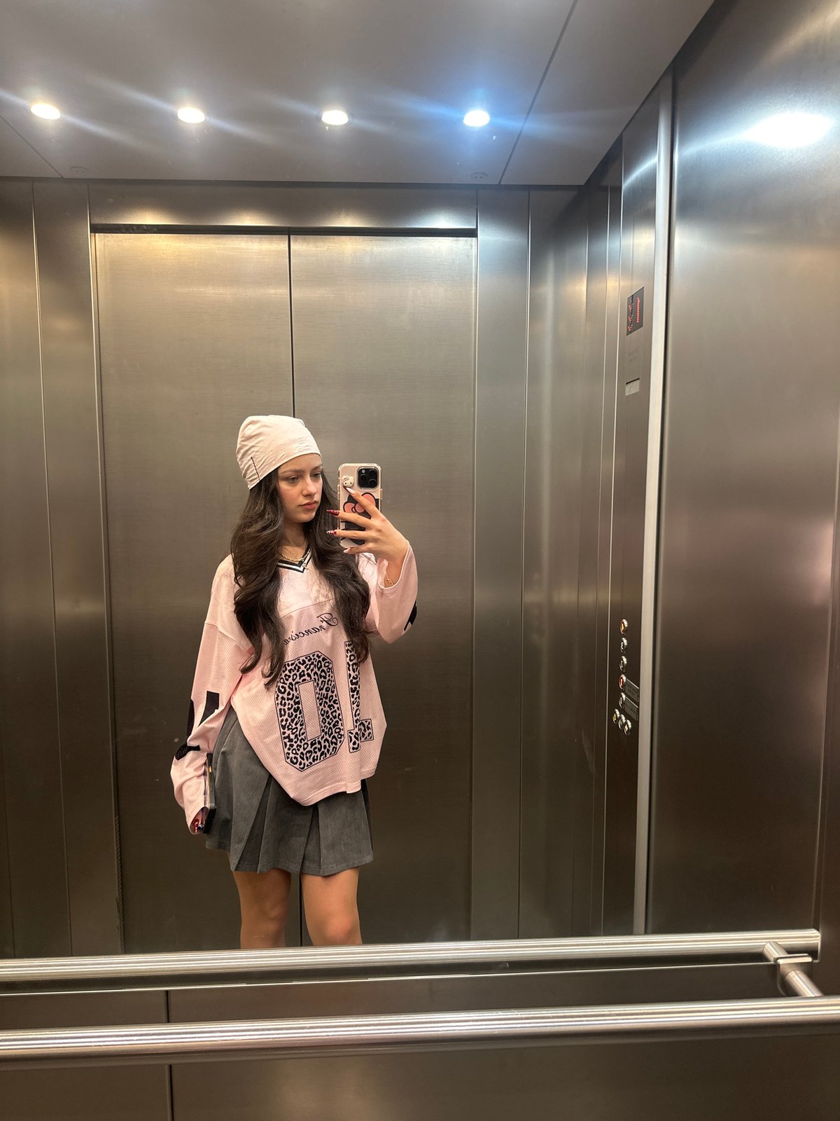 Woman takes elevator selfies in Yerevan during overcast evening