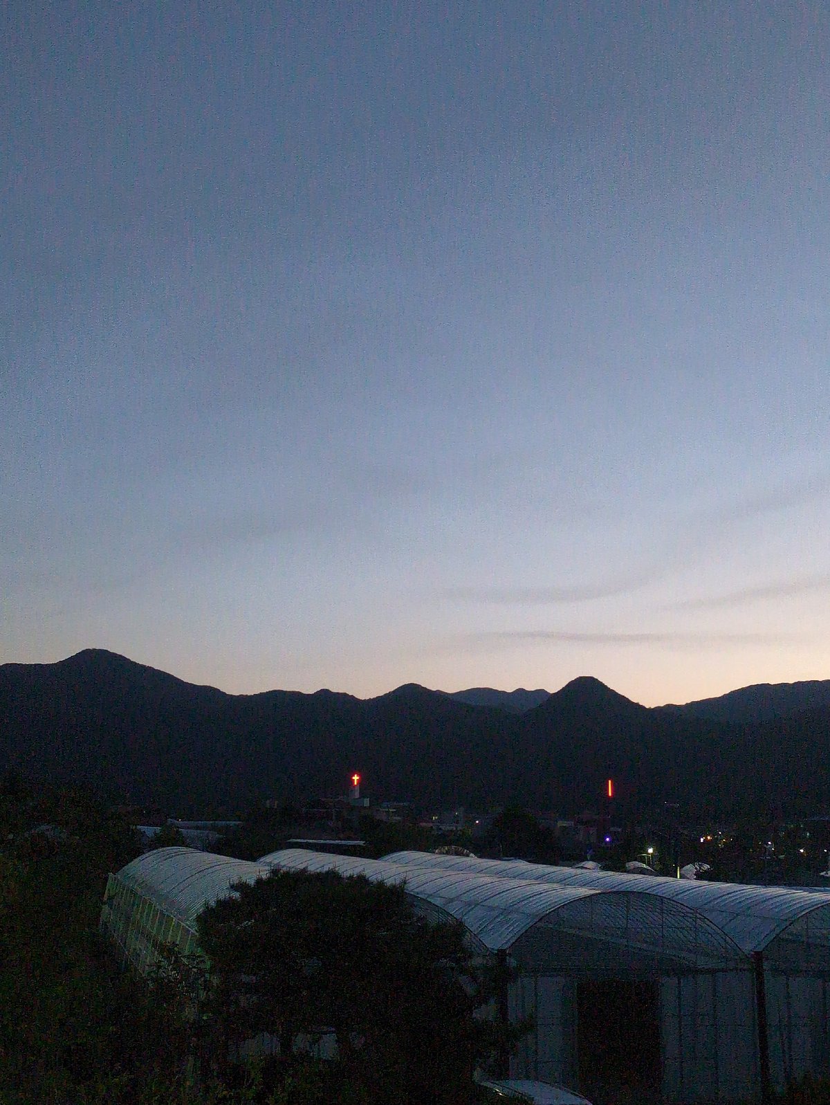 Twilight scene with mountains and modern architecture captured in Iwon