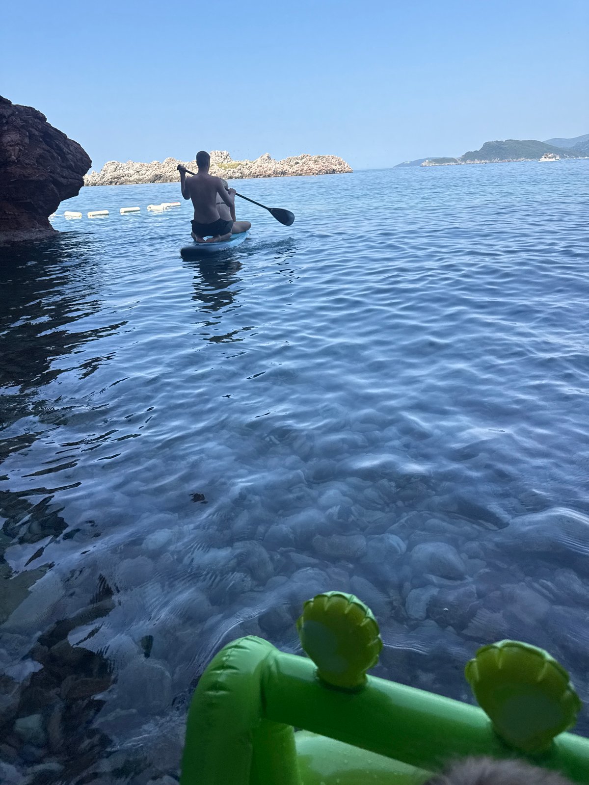 Paddleboarding the clear Adriatic waters off Sveti Stefan