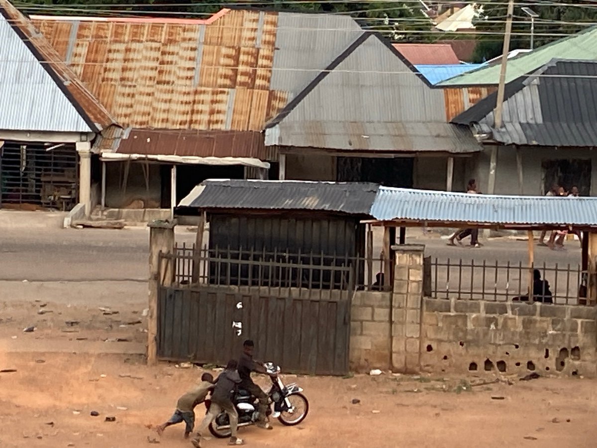Daily life captured in Nigerian neighborhood under gathering storm