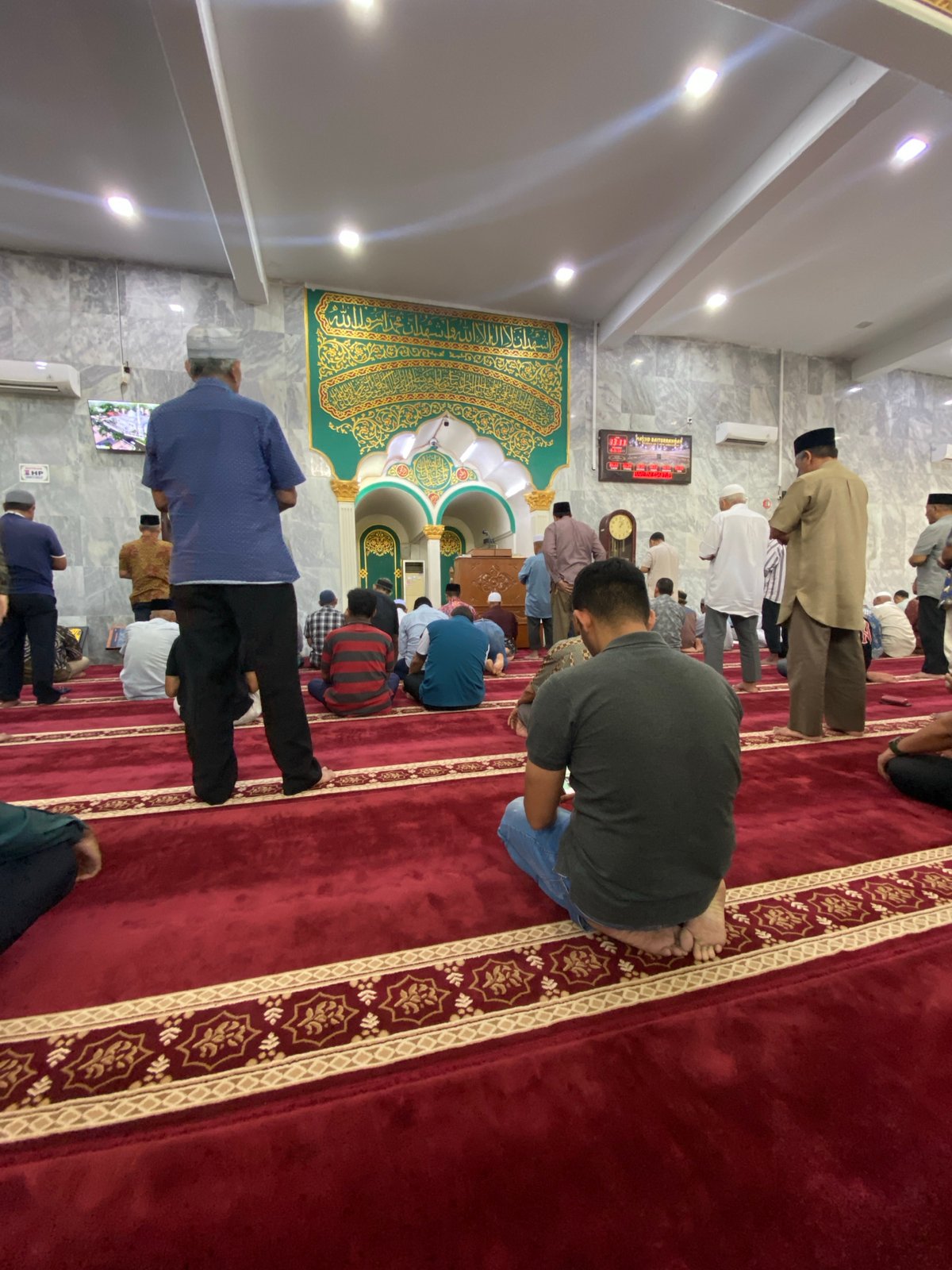 Morning congregation at prayer inside a Lhokseumawe mosque