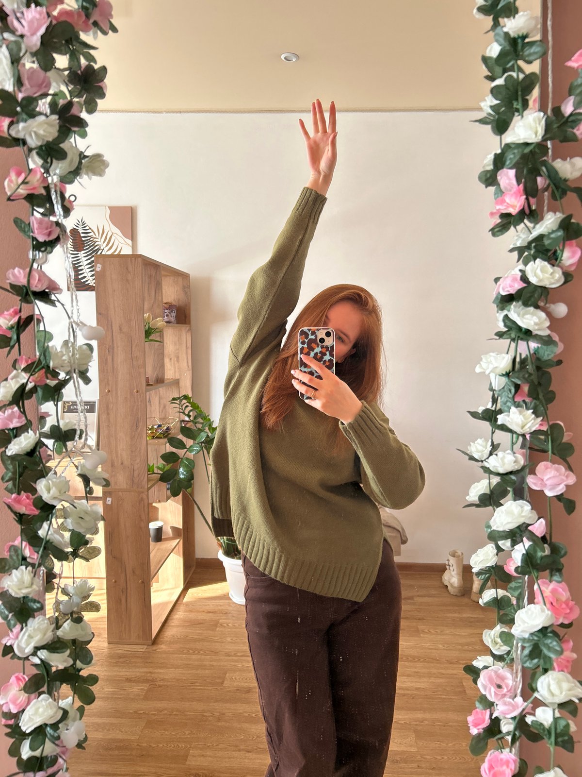 Woman takes multiple selfies in decorated room in Chaikovsky
