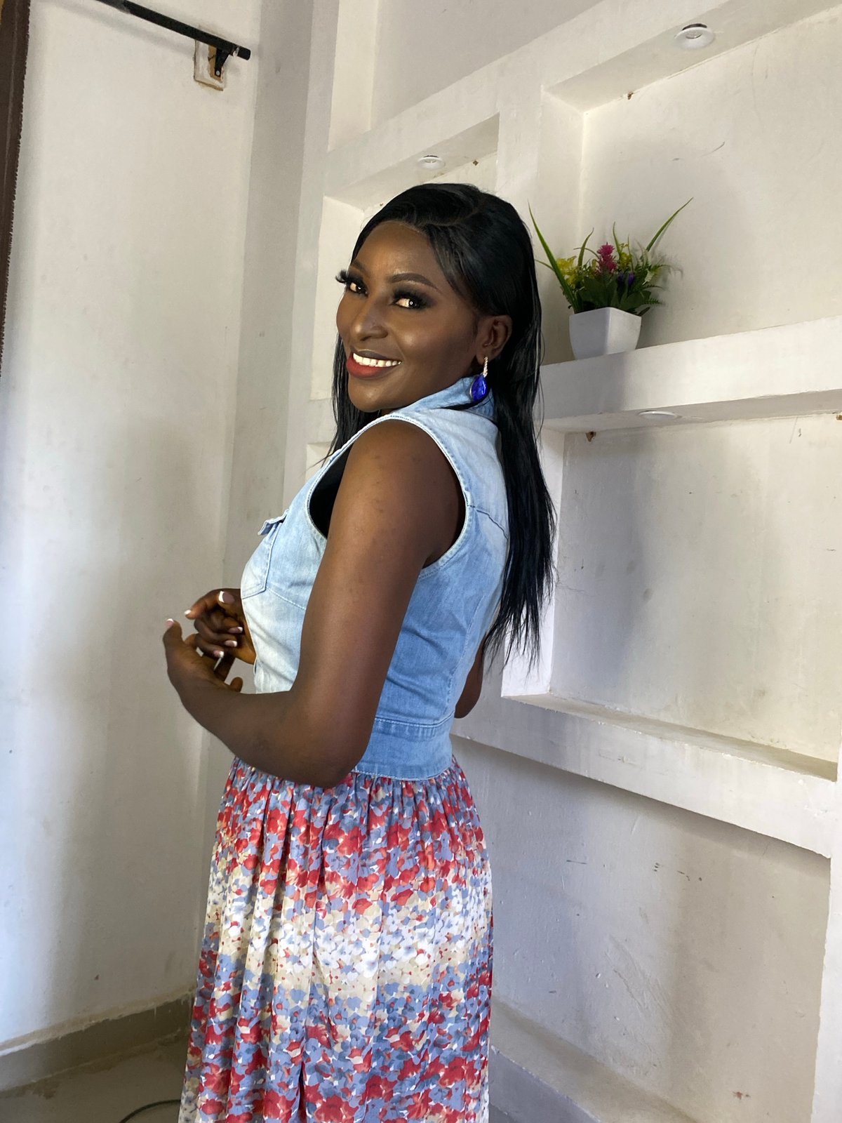 Woman poses for indoor portrait session in denim and florals