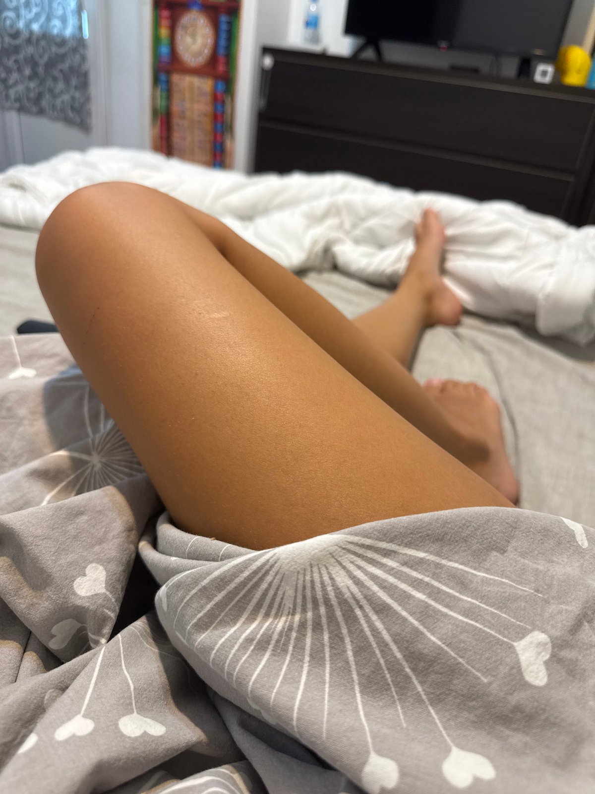 Relaxing on patterned sheets in a Chișinău bedroom