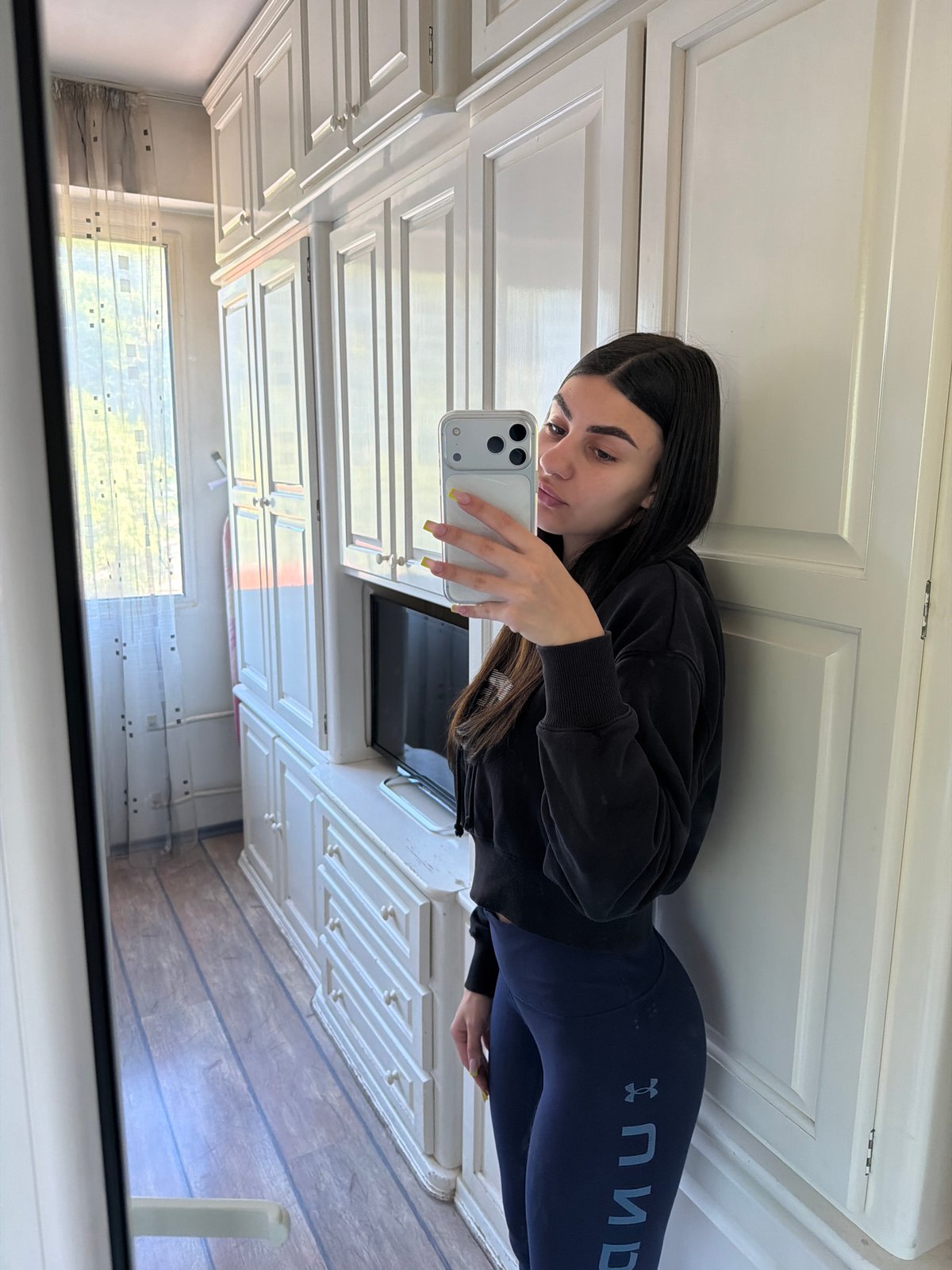 Woman takes mirror selfies in Gabrovo bathroom early morning