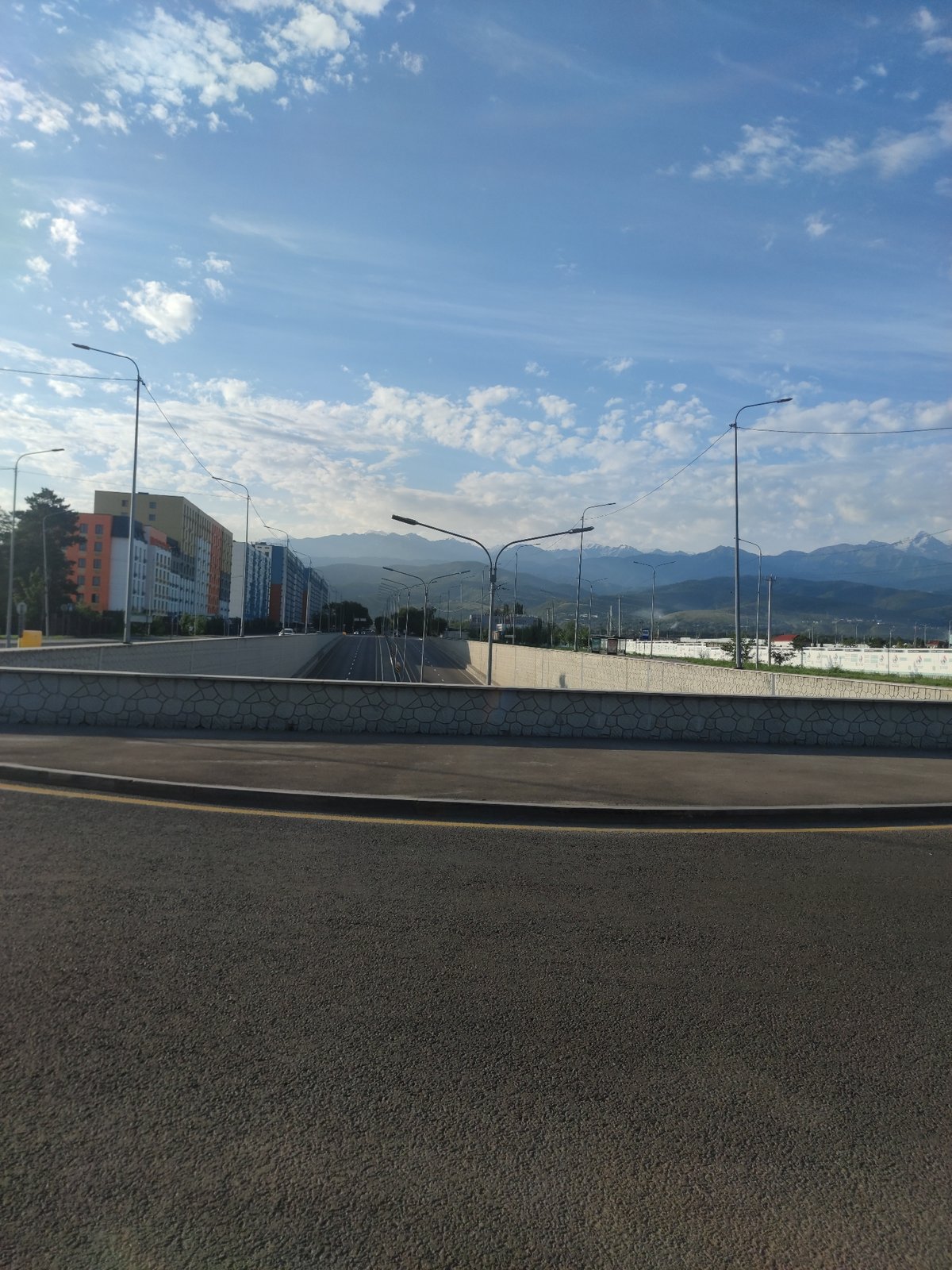 Almaty overpass district: city streets meet mountain backdrop