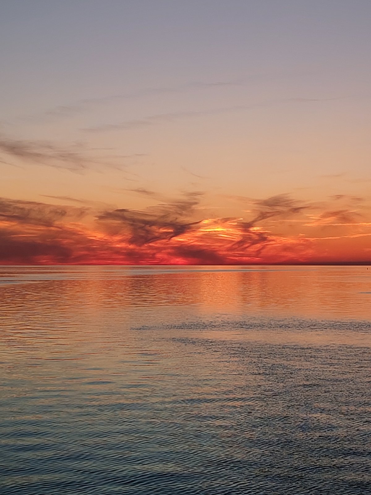Sunset photographed over water in Bol'shie Mkhi, Russia
