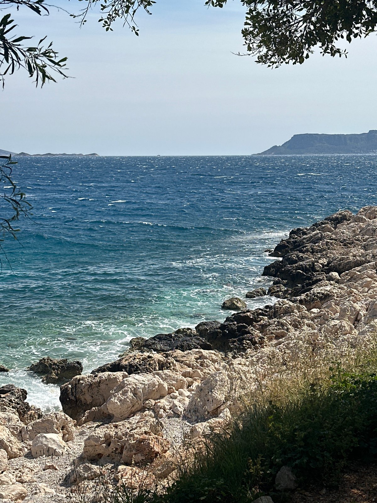 Waves crash against rocky coastline in Kaş, Turkey