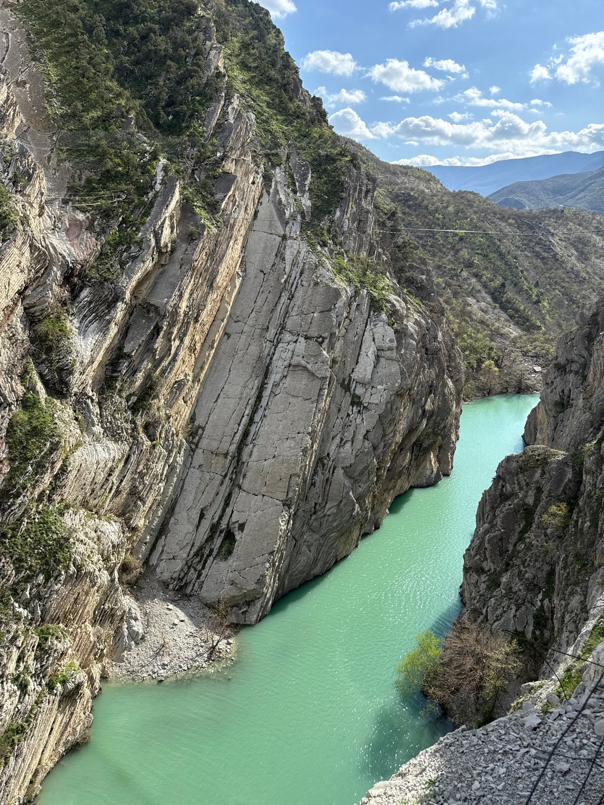 Workers view turquoise canyon river from platform in Russia