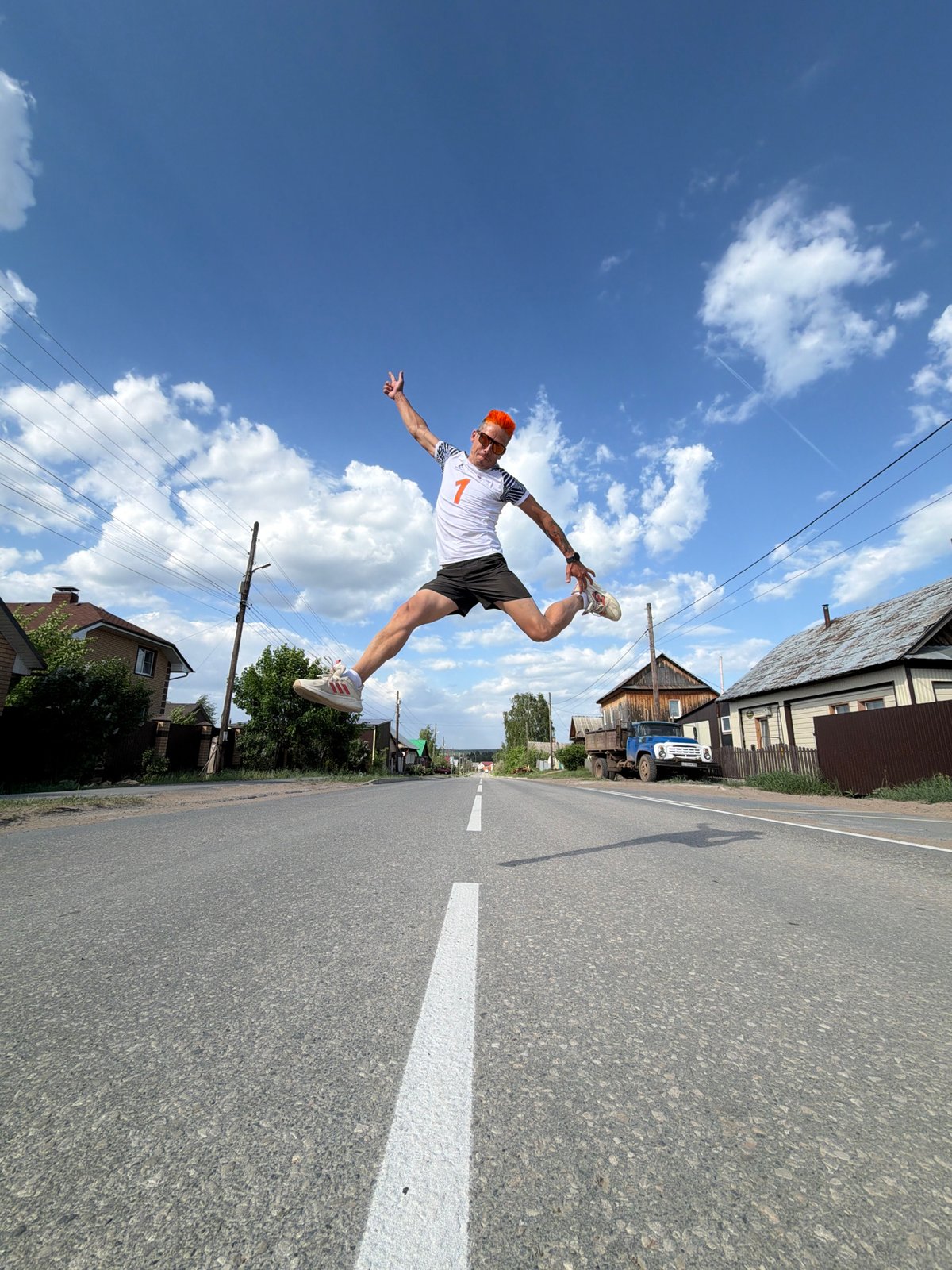 Orange-haired man performs street acrobatics in Chaikovsky, Russia
