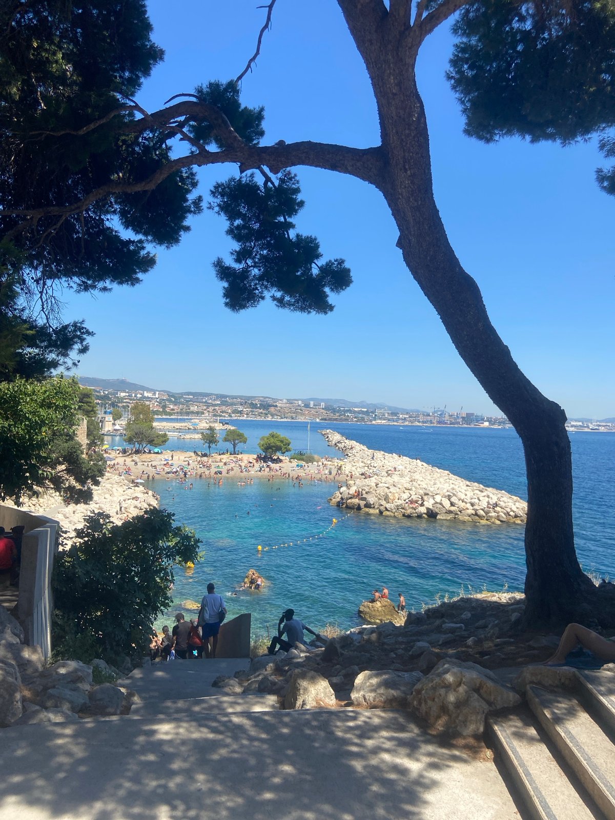 Crowded beach and bay on a bright, busy afternoon