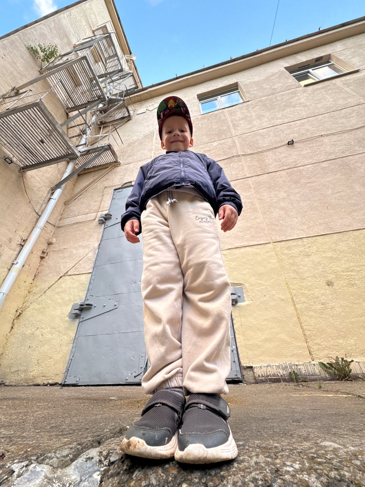 Afternoon hang in Chaikovsky: buildings, skies, and a kid outside