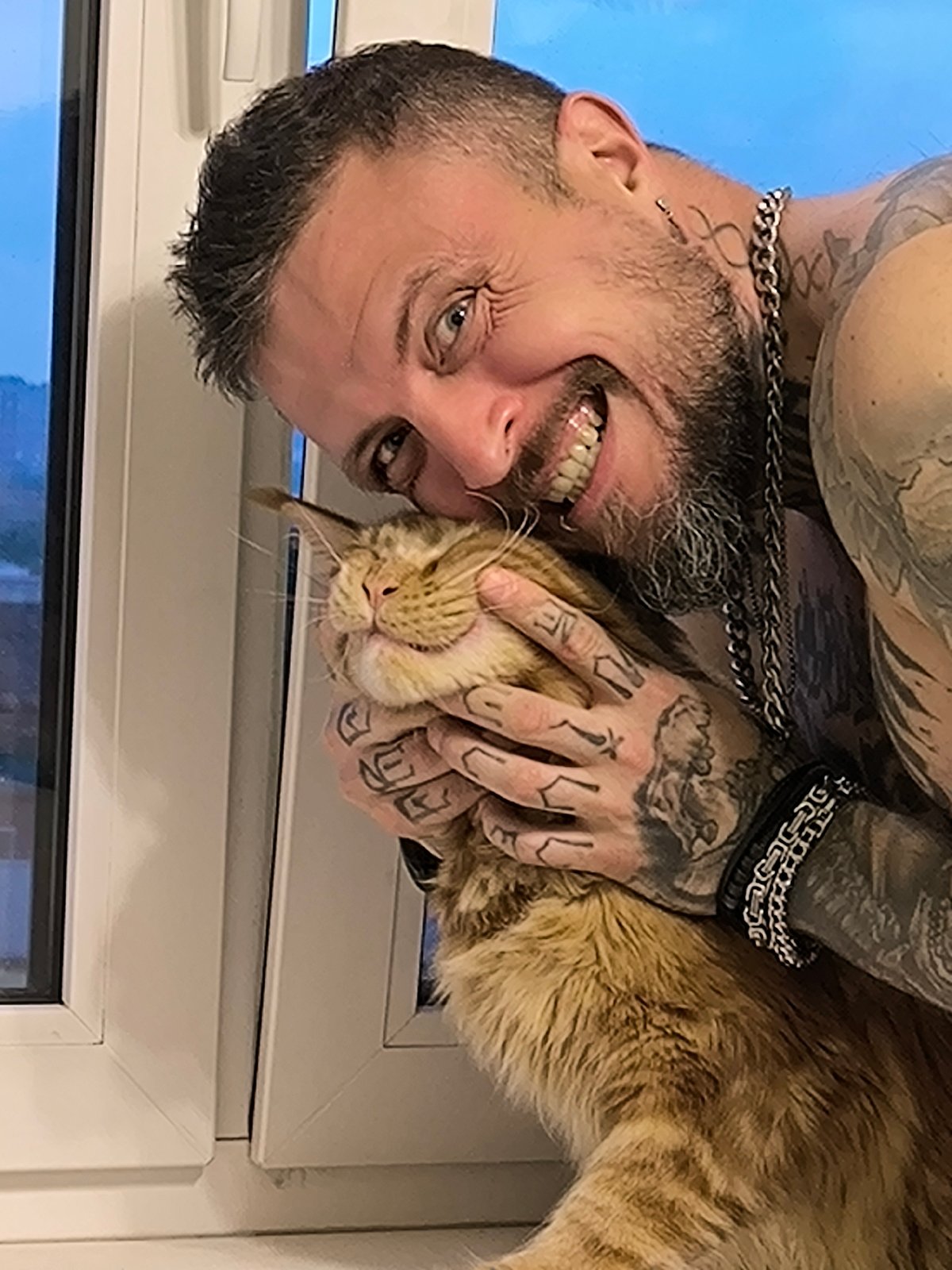 Cat cuddles by window frame in Saint Petersburg