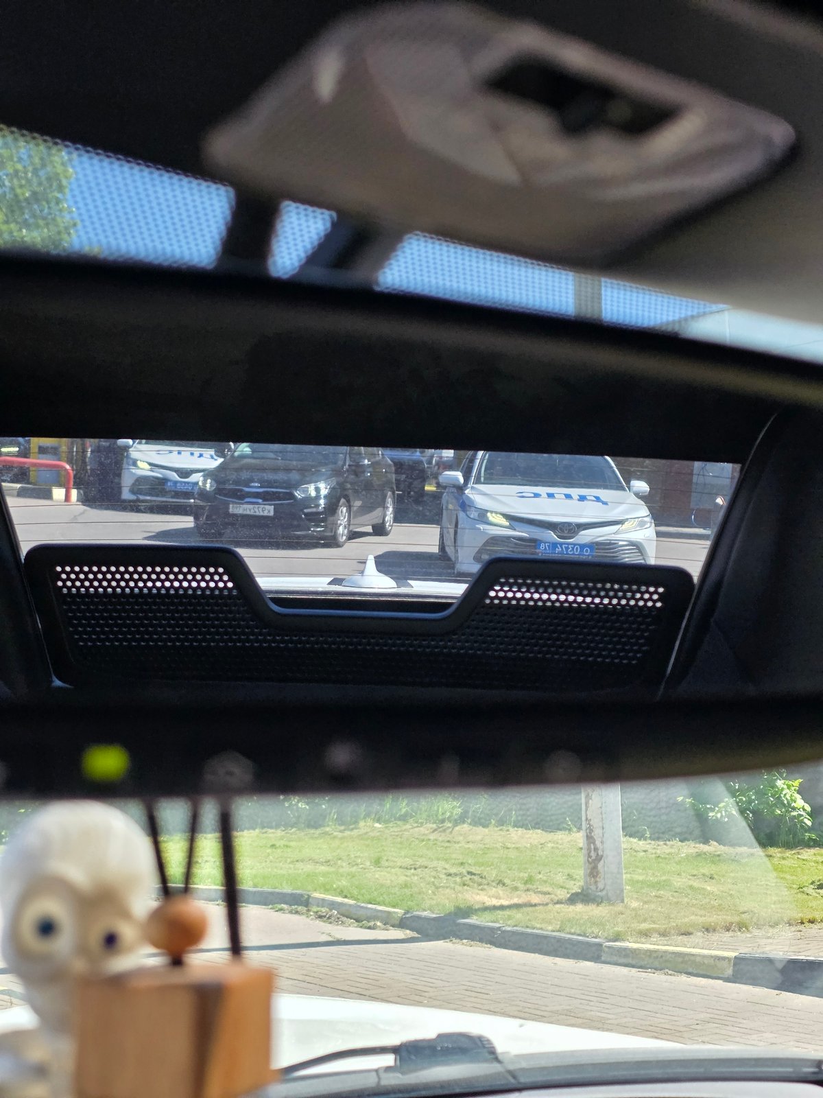 Vehicle rear window reflection shows parked cars in Saint Petersburg