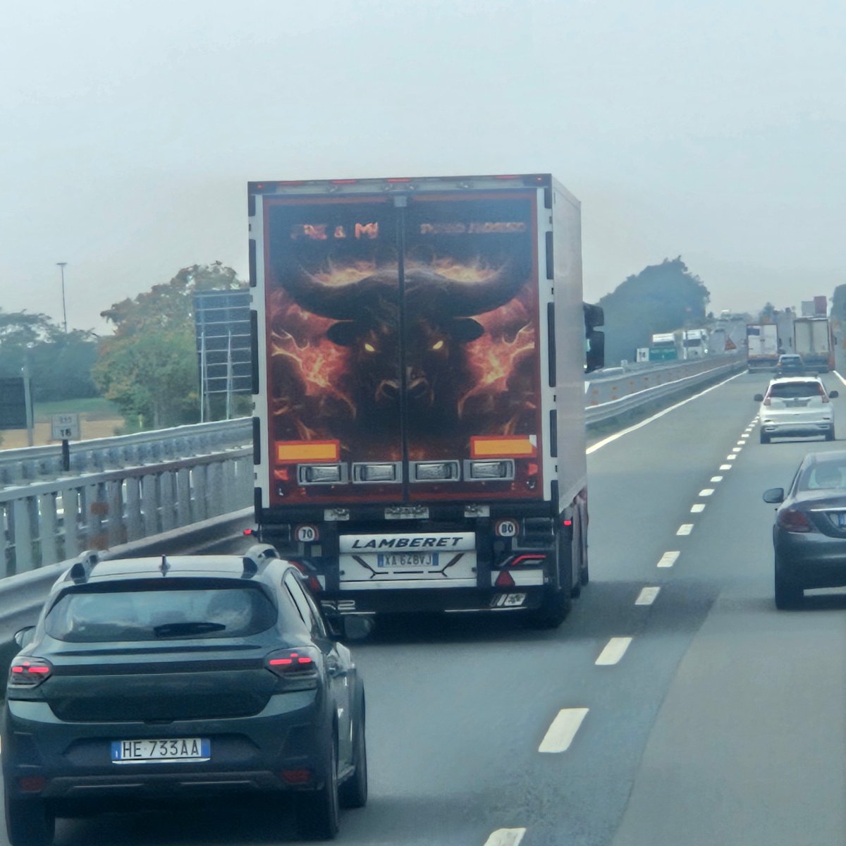 Bull-branded semi-truck on the highway through Pozzolo Formigaro