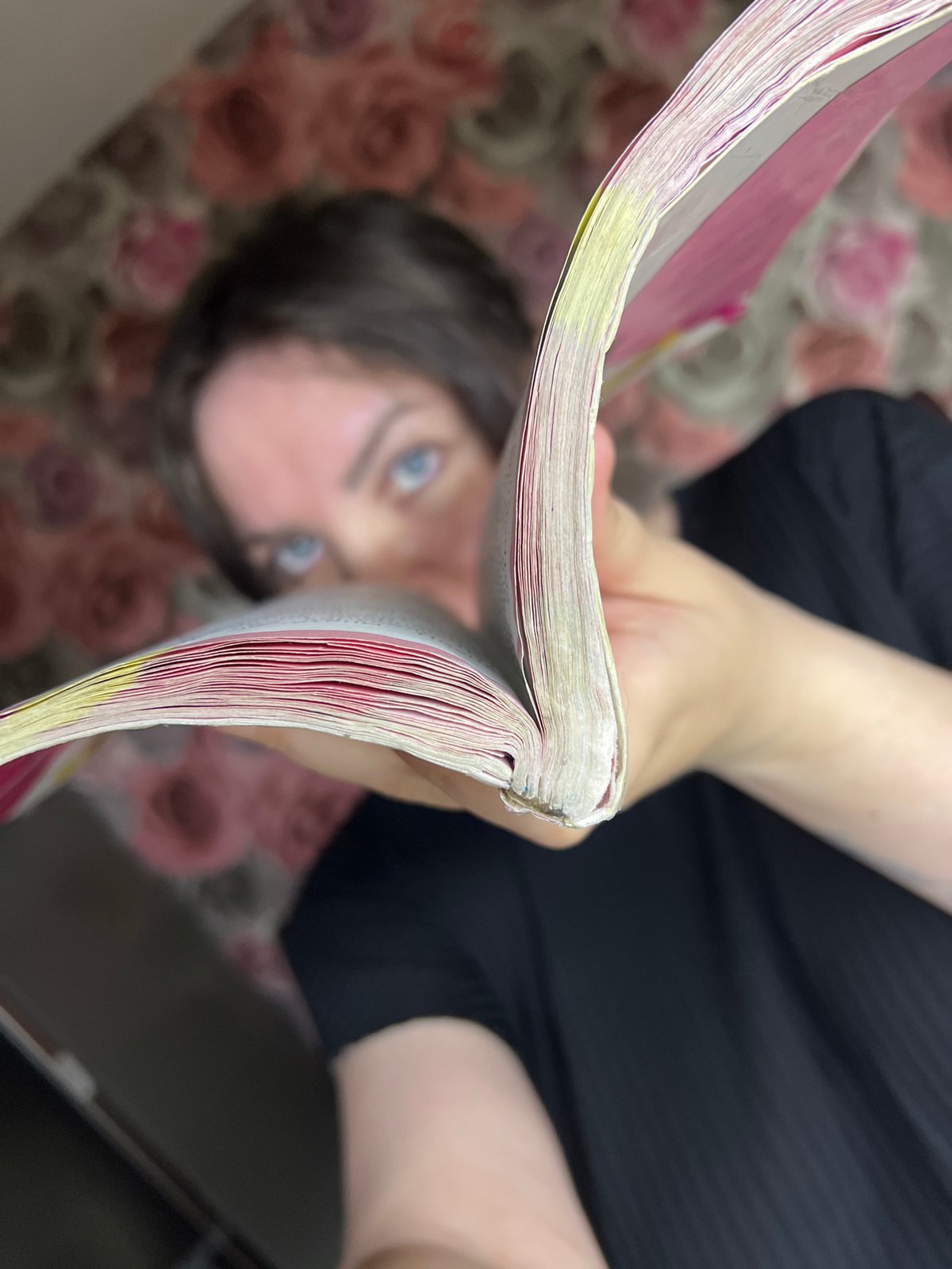 Person reads highlighted Russian book in Noviy evening scene