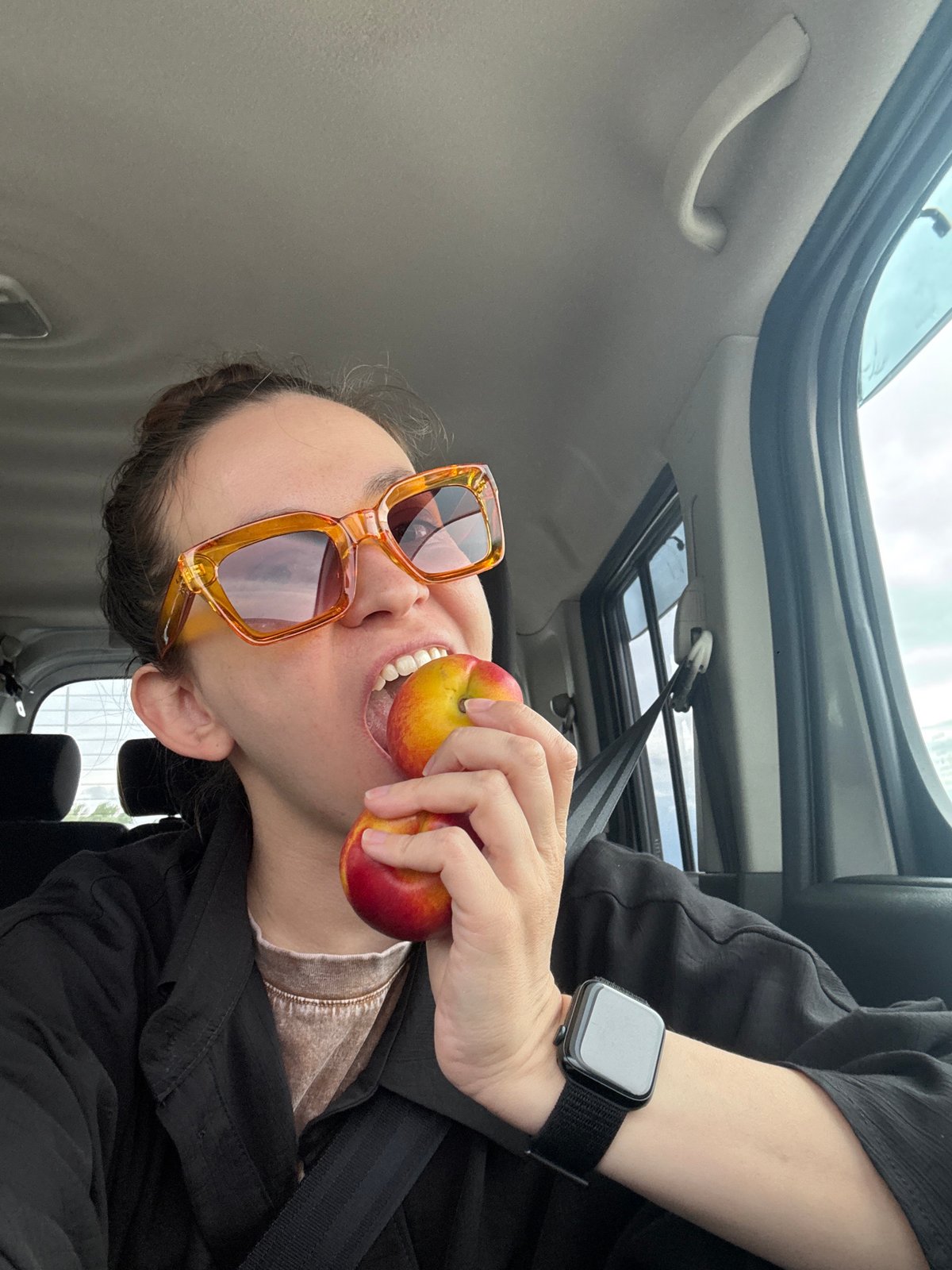 Traveler poses playfully with fruit during Russian road trip